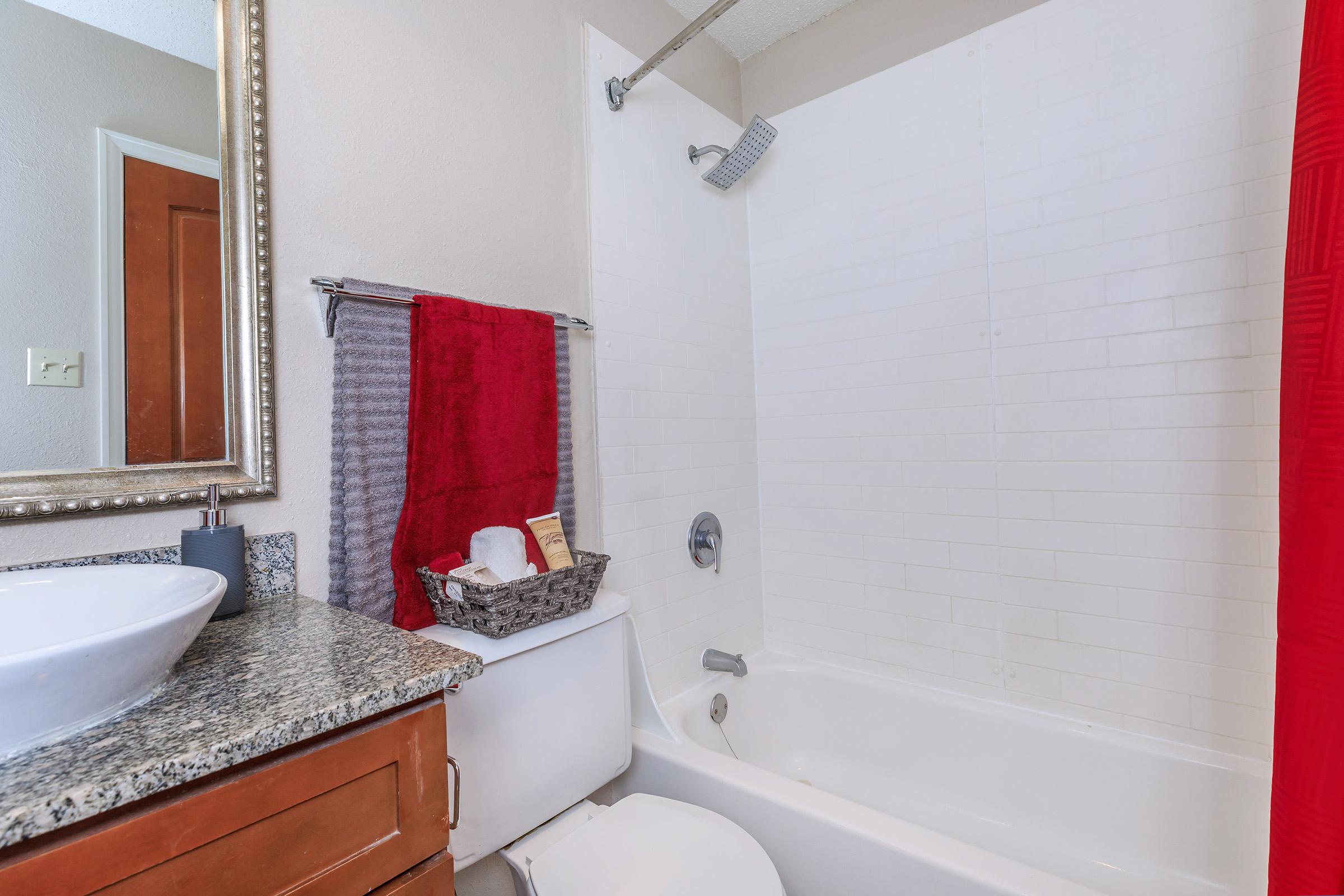 a room with a sink shower and tub