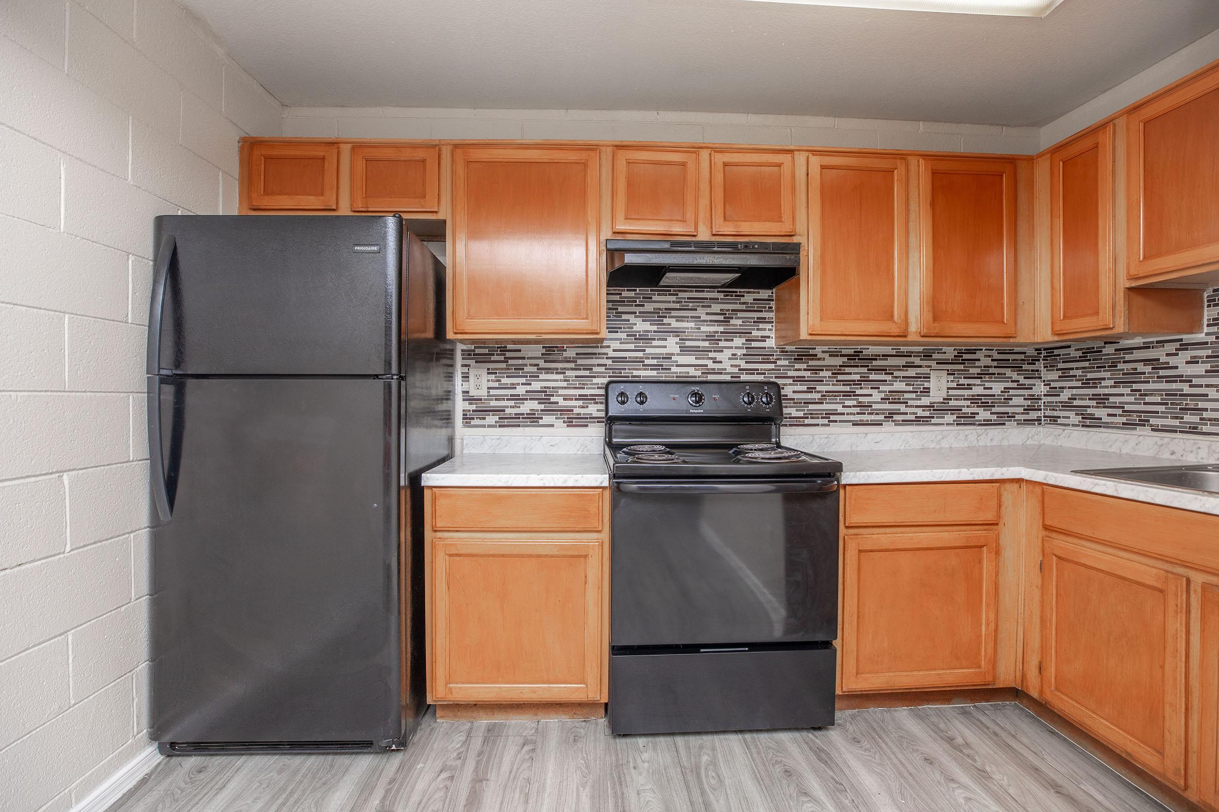 a kitchen with stainless steel appliances and wooden cabinets