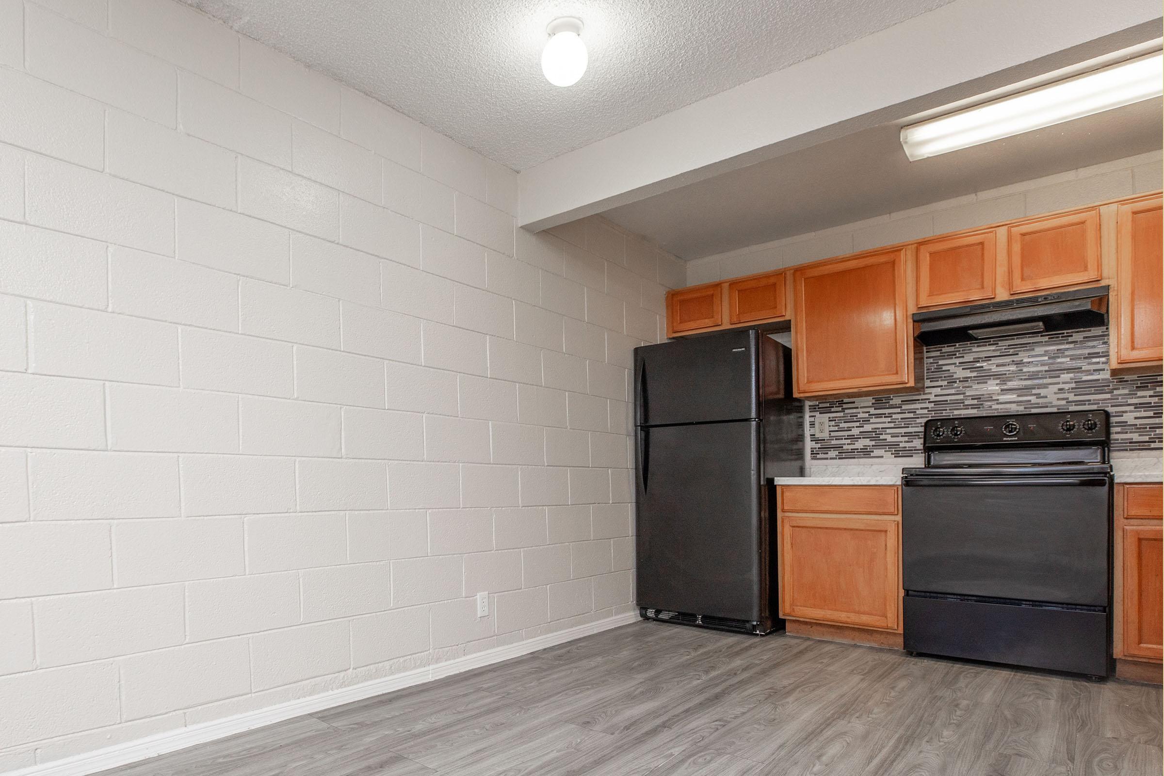 a kitchen with a stove and a refrigerator