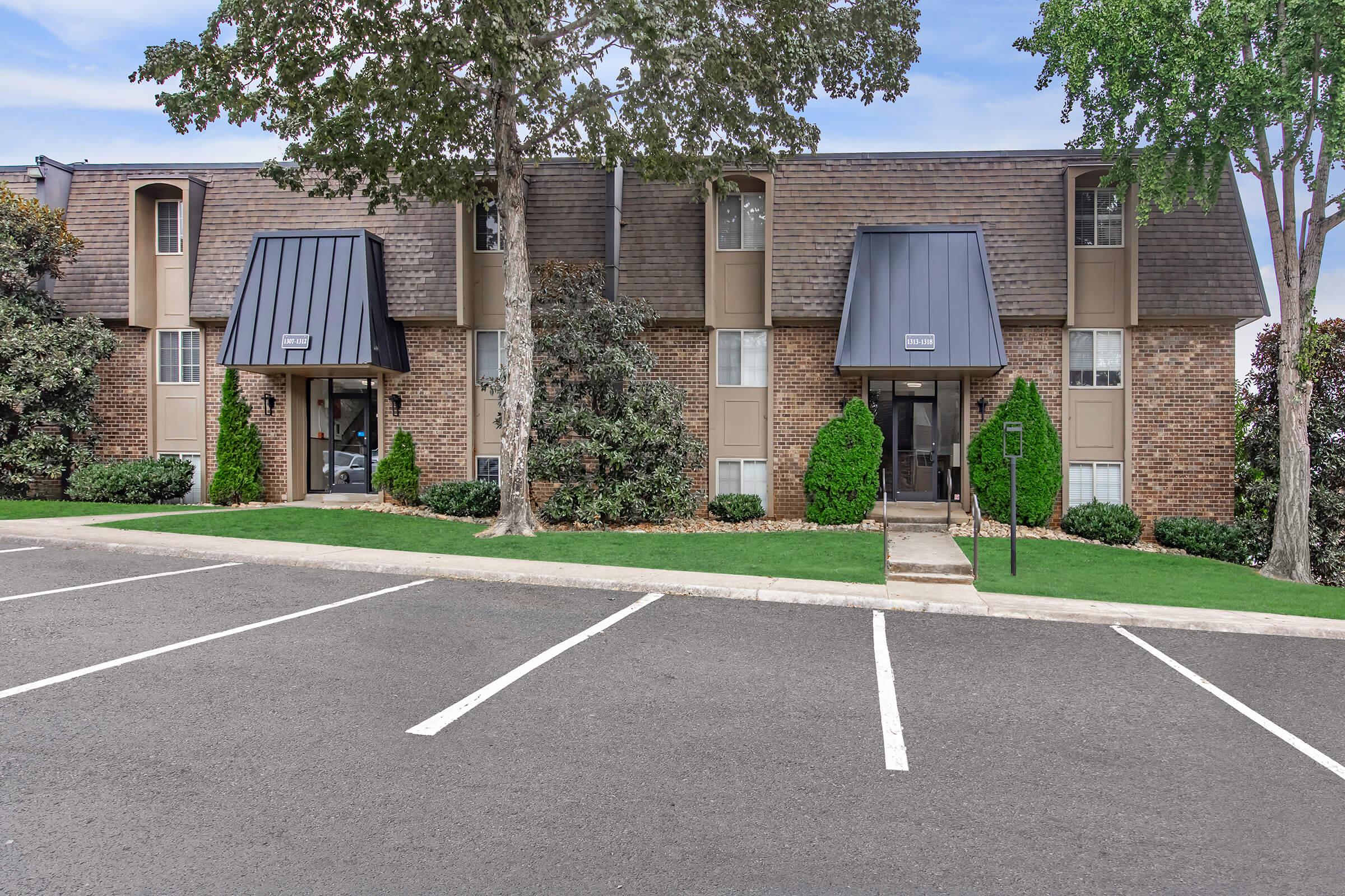 an empty parking lot in front of a house