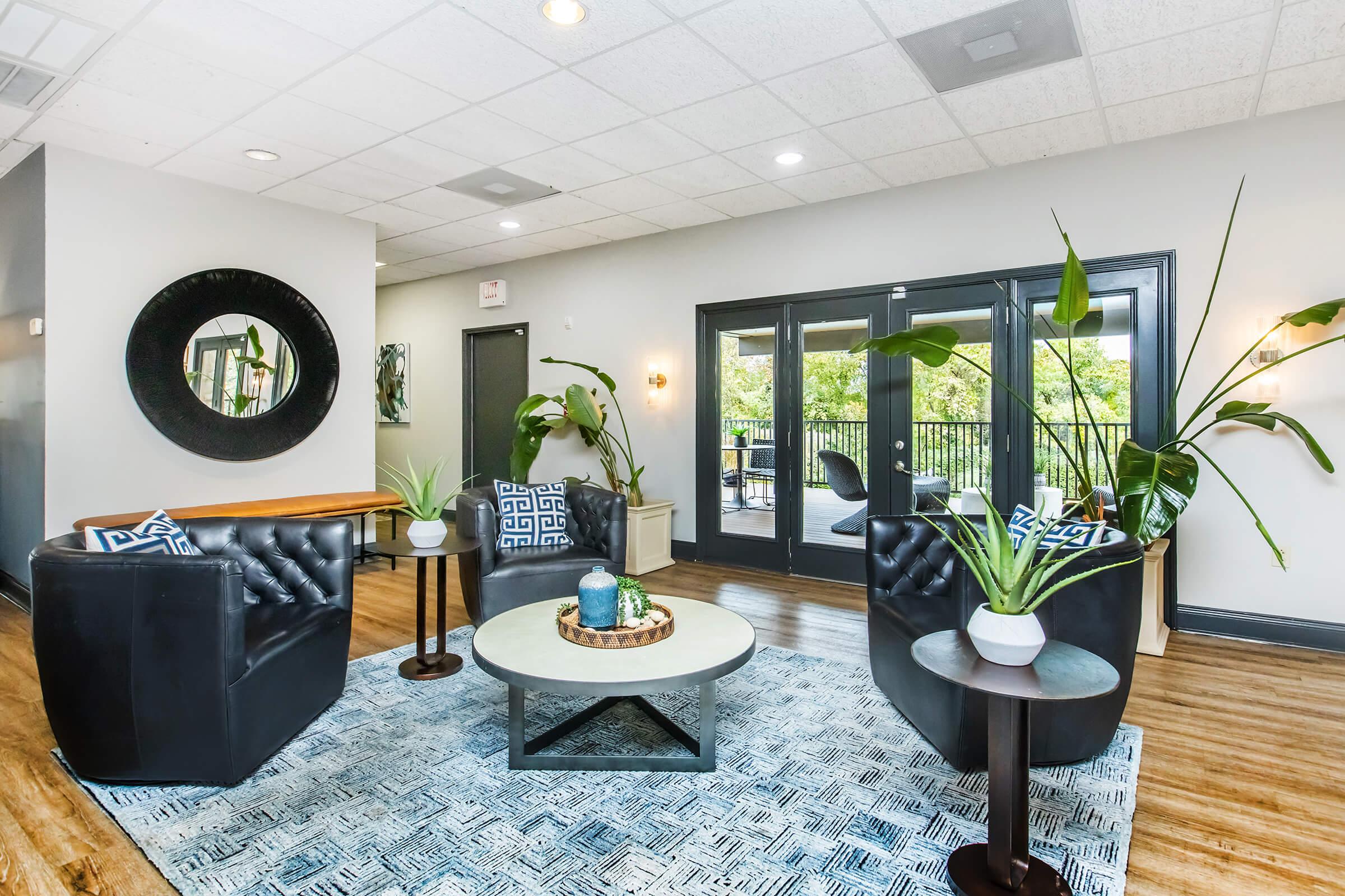 a living room filled with furniture and a large window