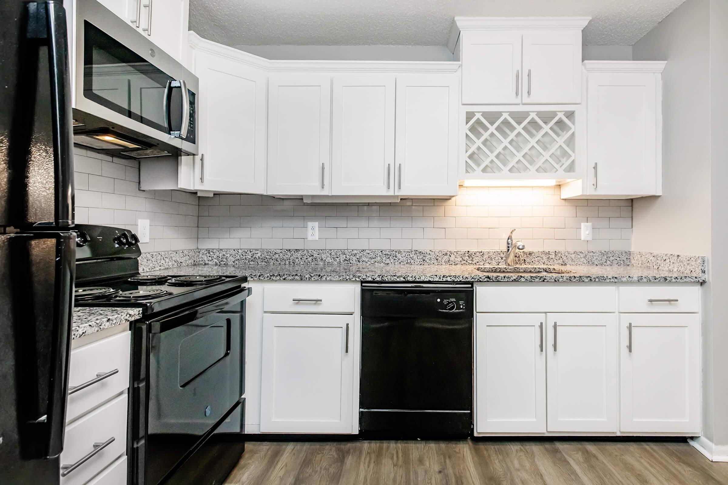 a stove top oven sitting inside of a kitchen