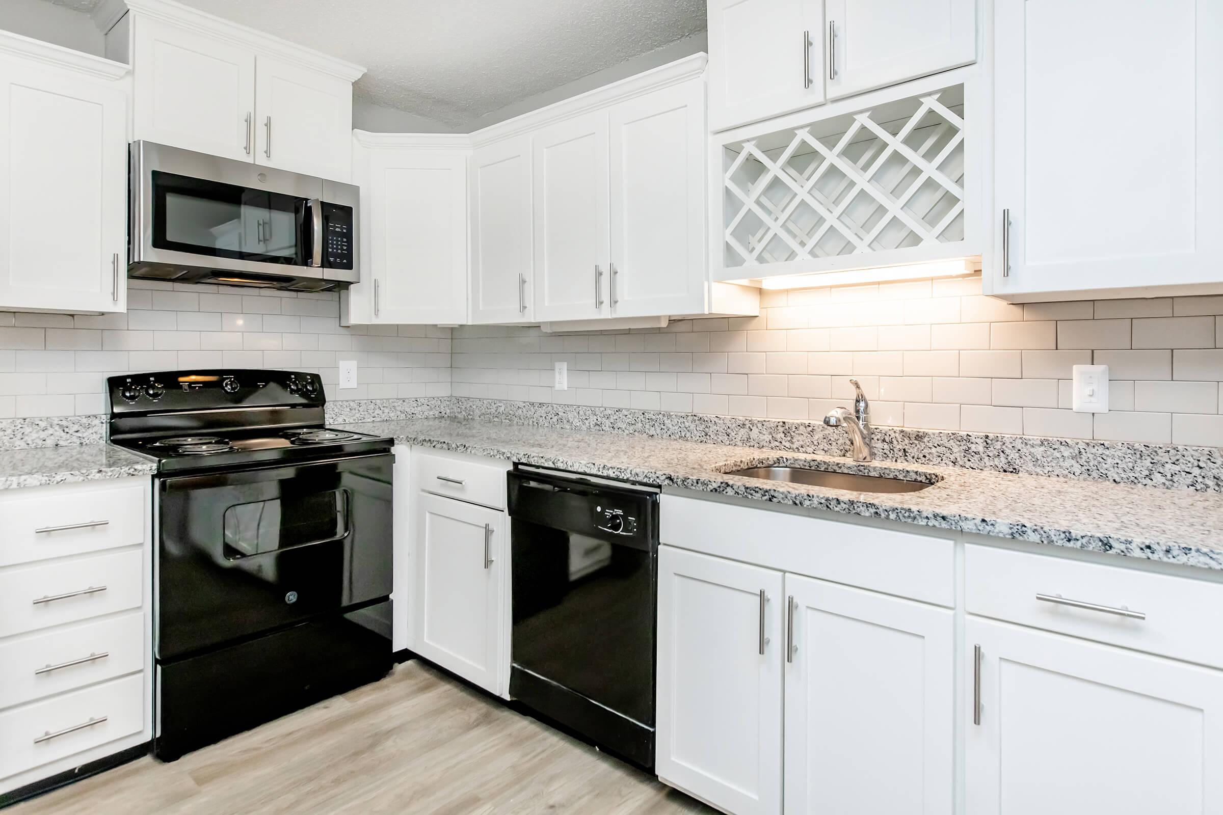 a kitchen with a stove and a microwave