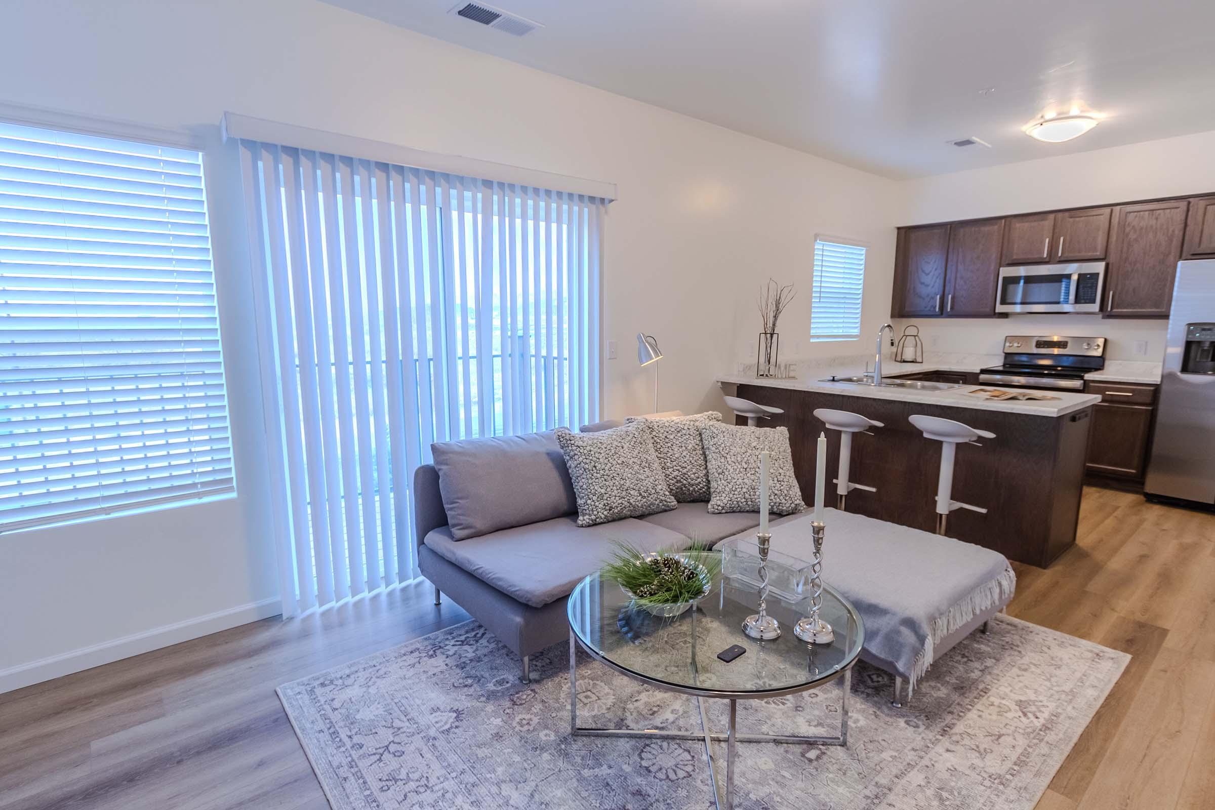 a living room filled with furniture and a large window