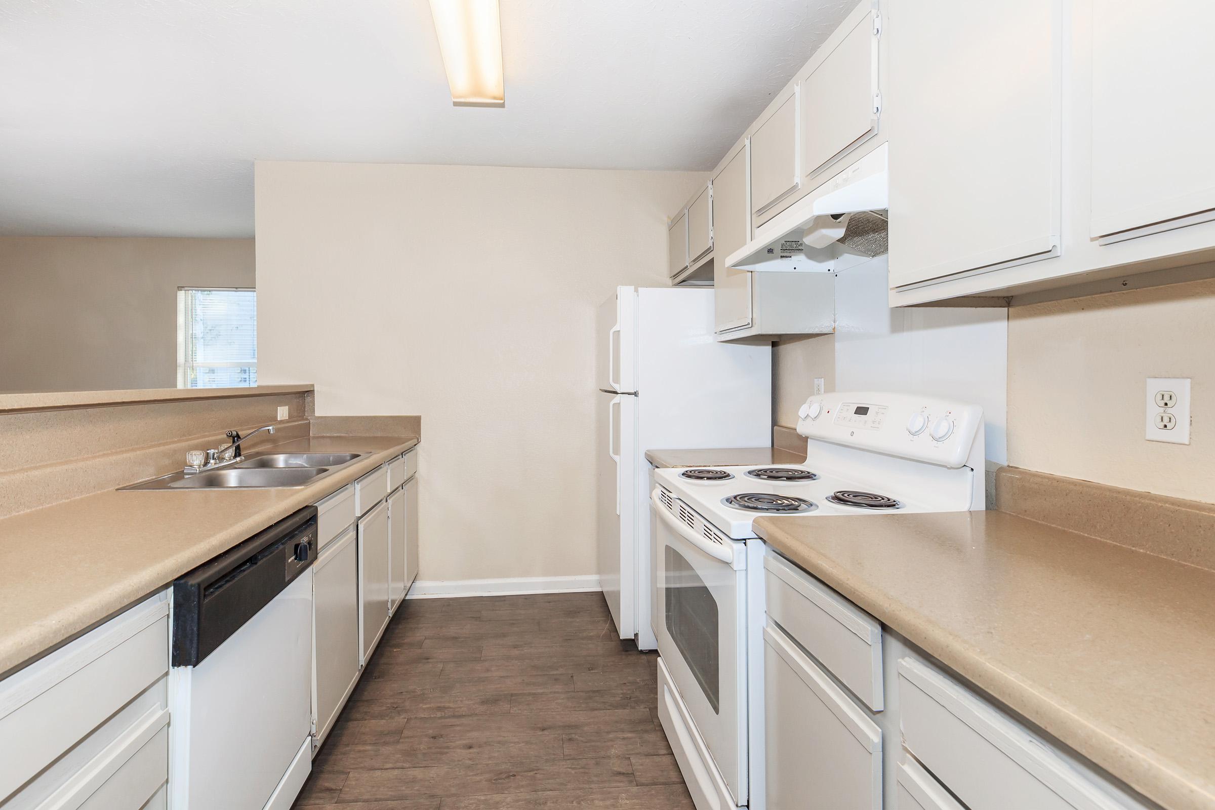 a kitchen with a stove and a sink