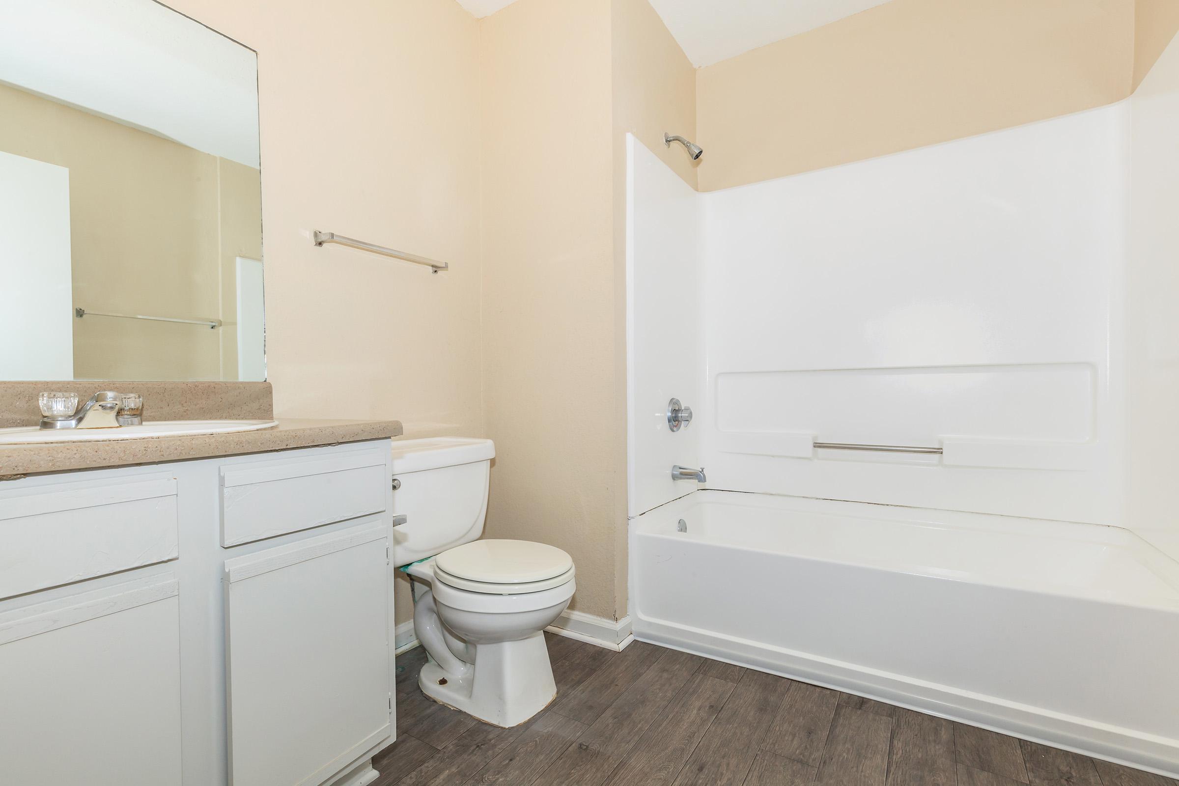 a white tub sitting next to a sink