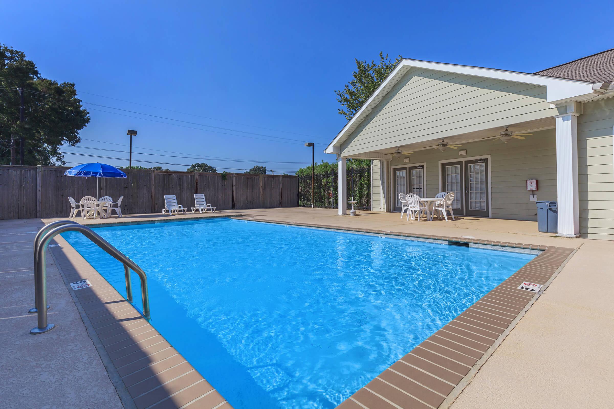 a house with a pool in front of a building