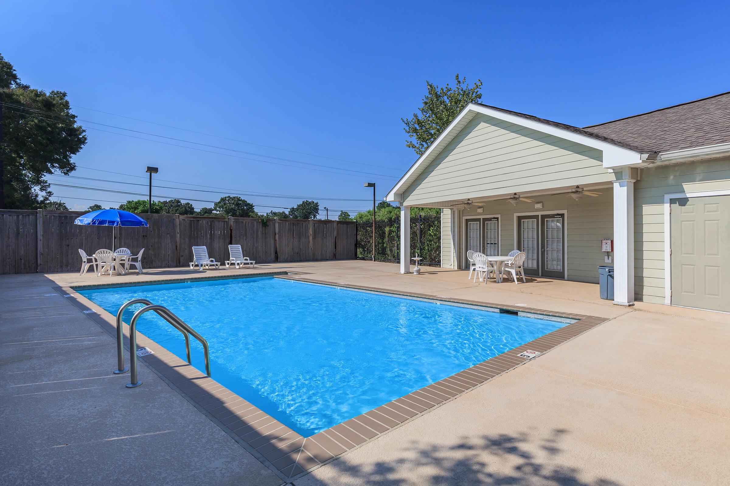 a house with a pool in front of a building