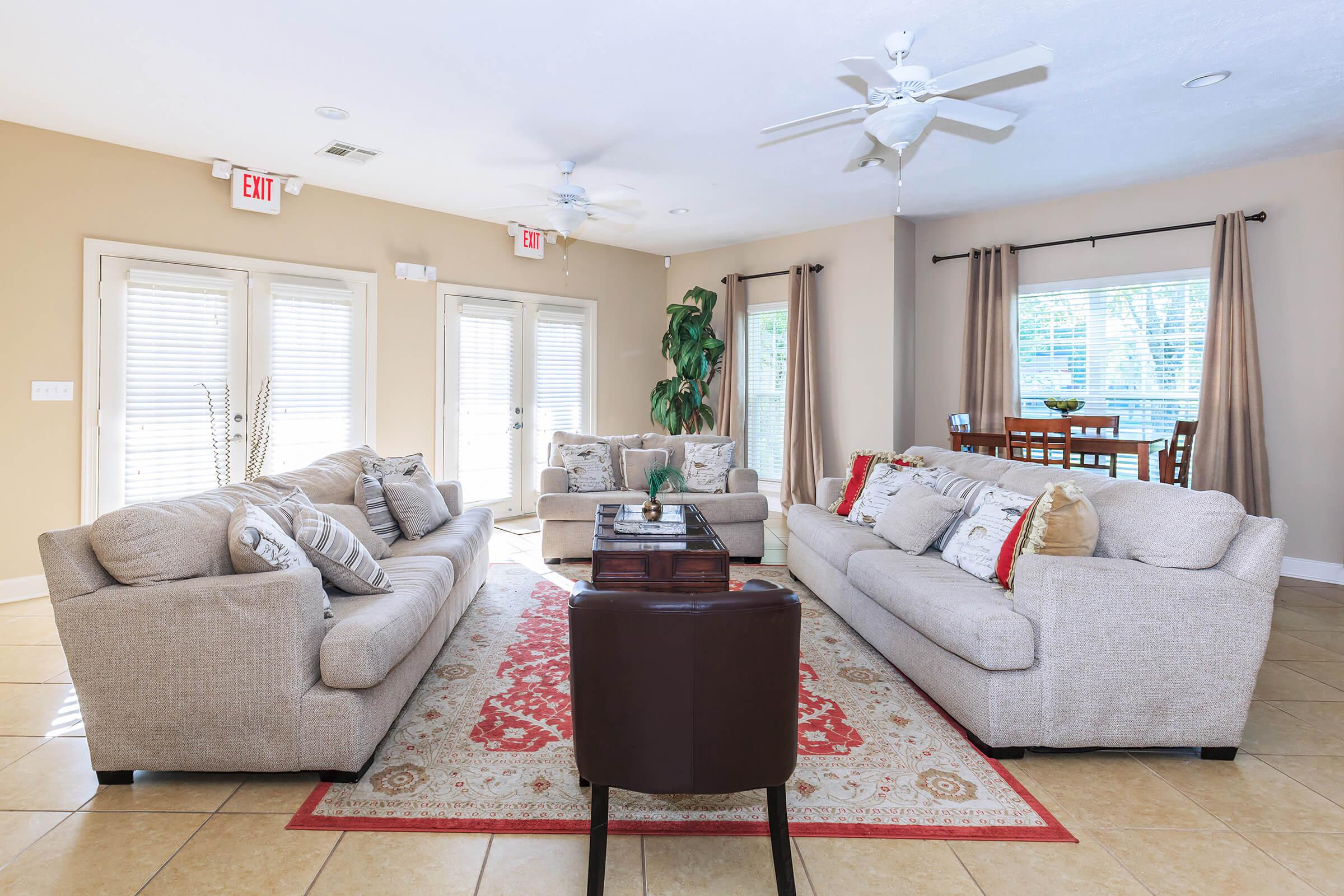 a living room filled with furniture and a large window