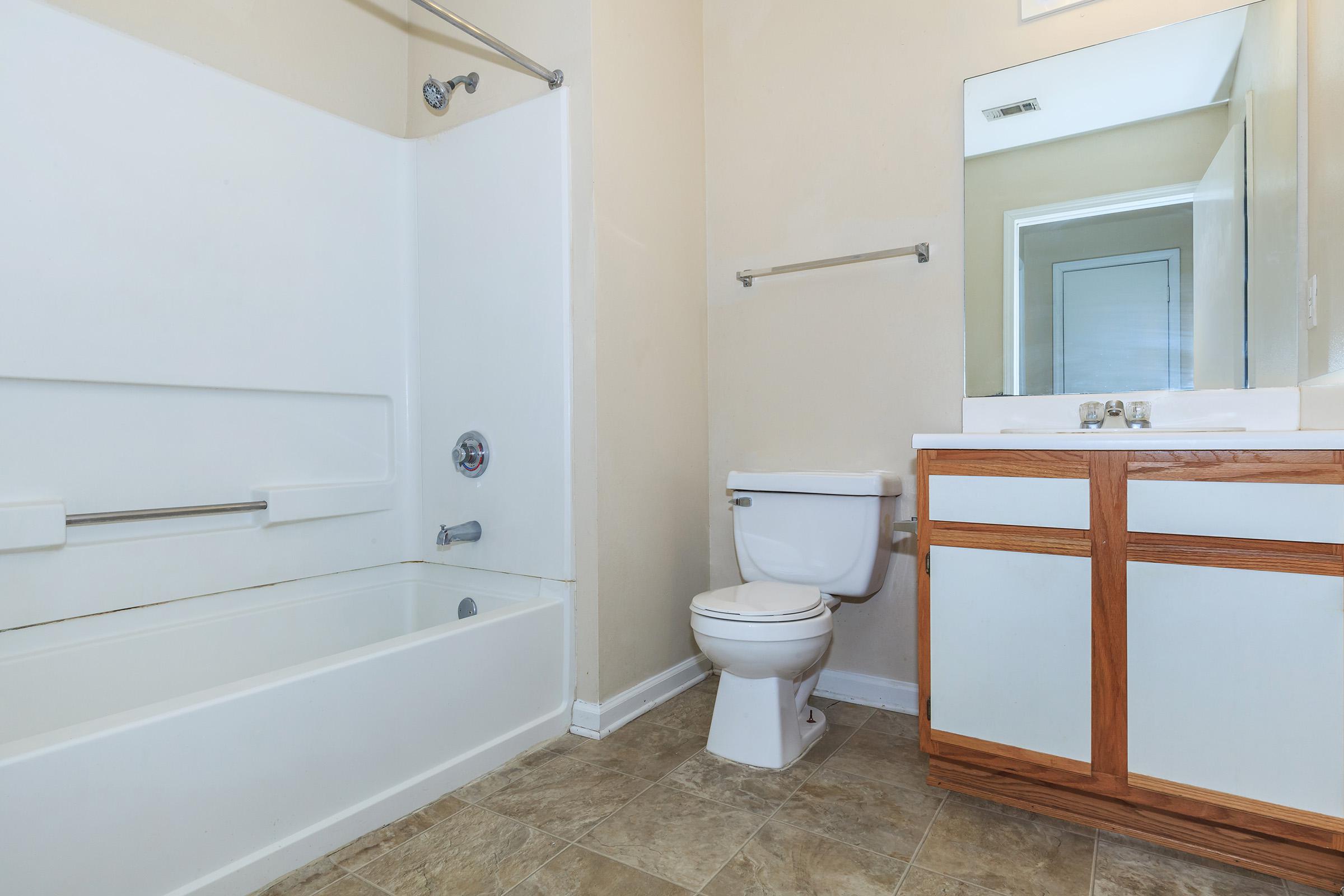 a large white tub sitting next to a window