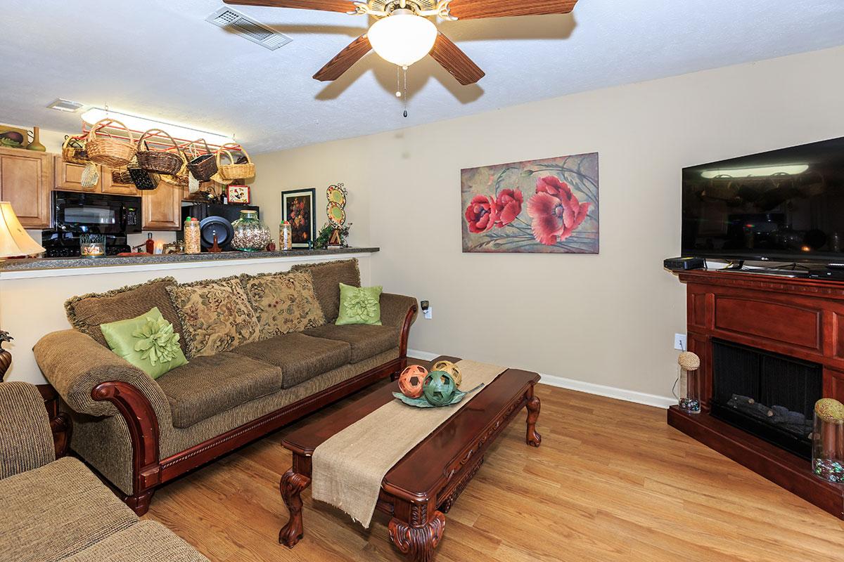 a living room filled with furniture and a flat screen tv