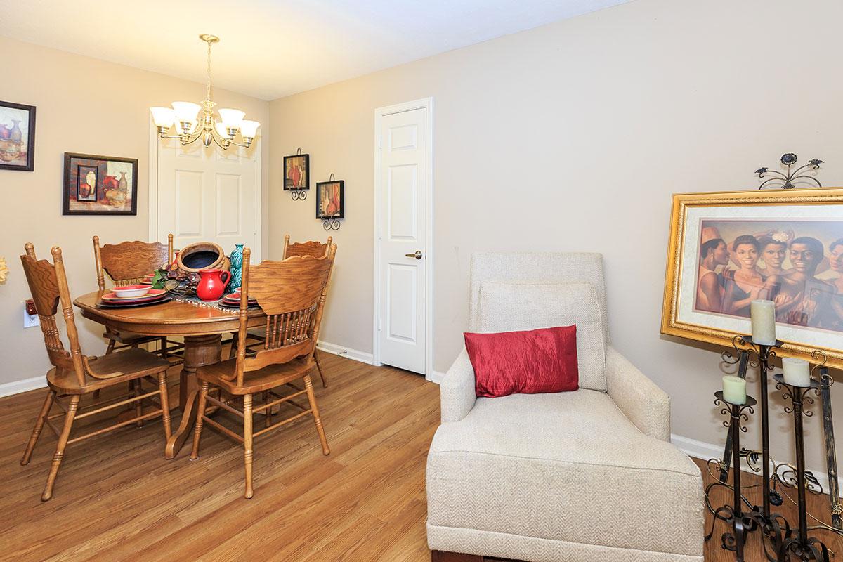 a living room filled with furniture on top of a wooden floor