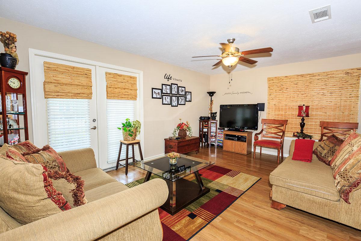 a living room filled with furniture and a flat screen tv