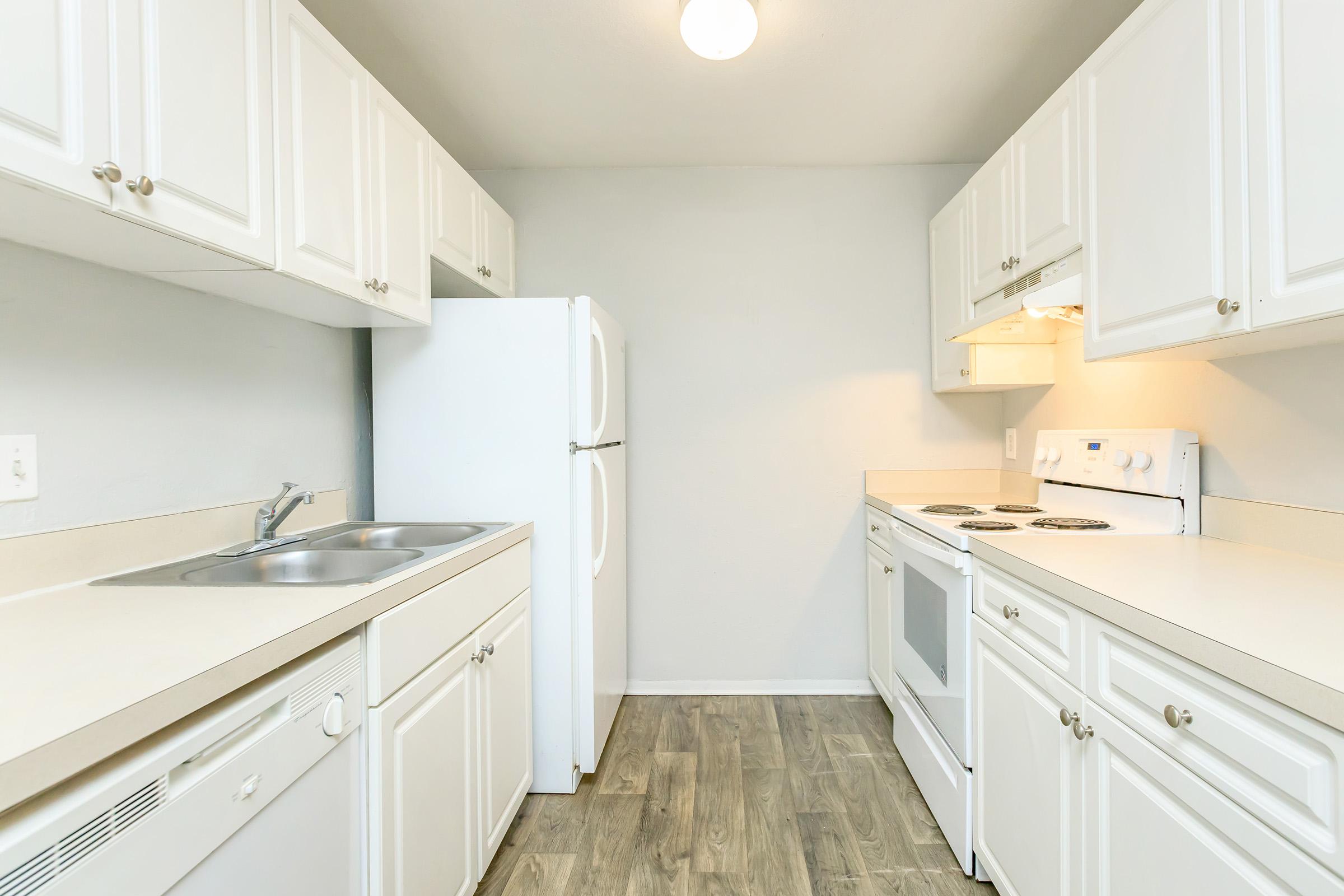 a kitchen with a sink and a refrigerator