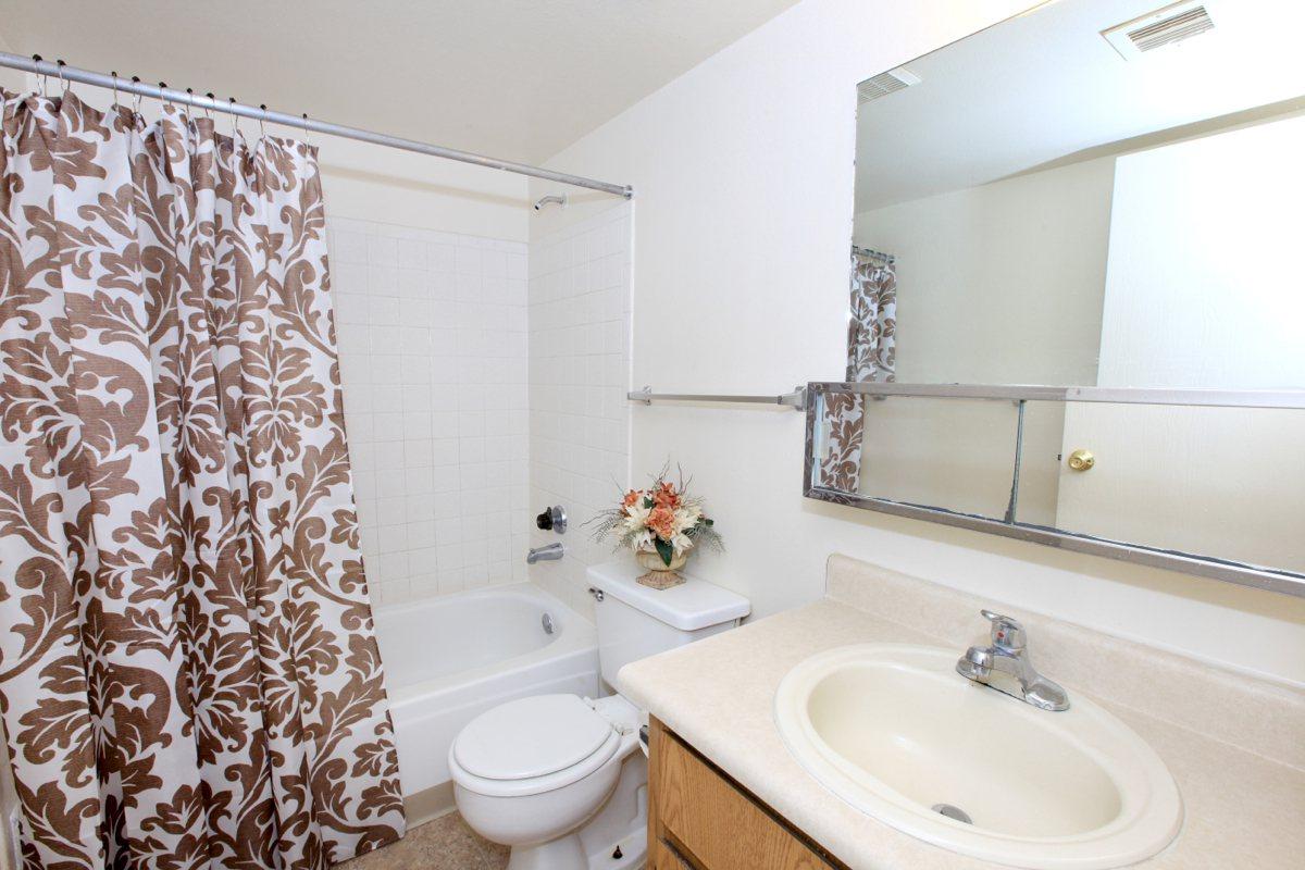 a white sink and a mirror