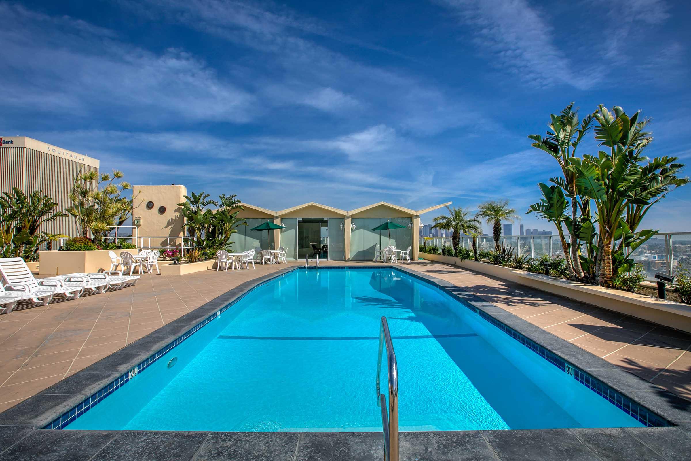 a swimming pool with lounge chairs