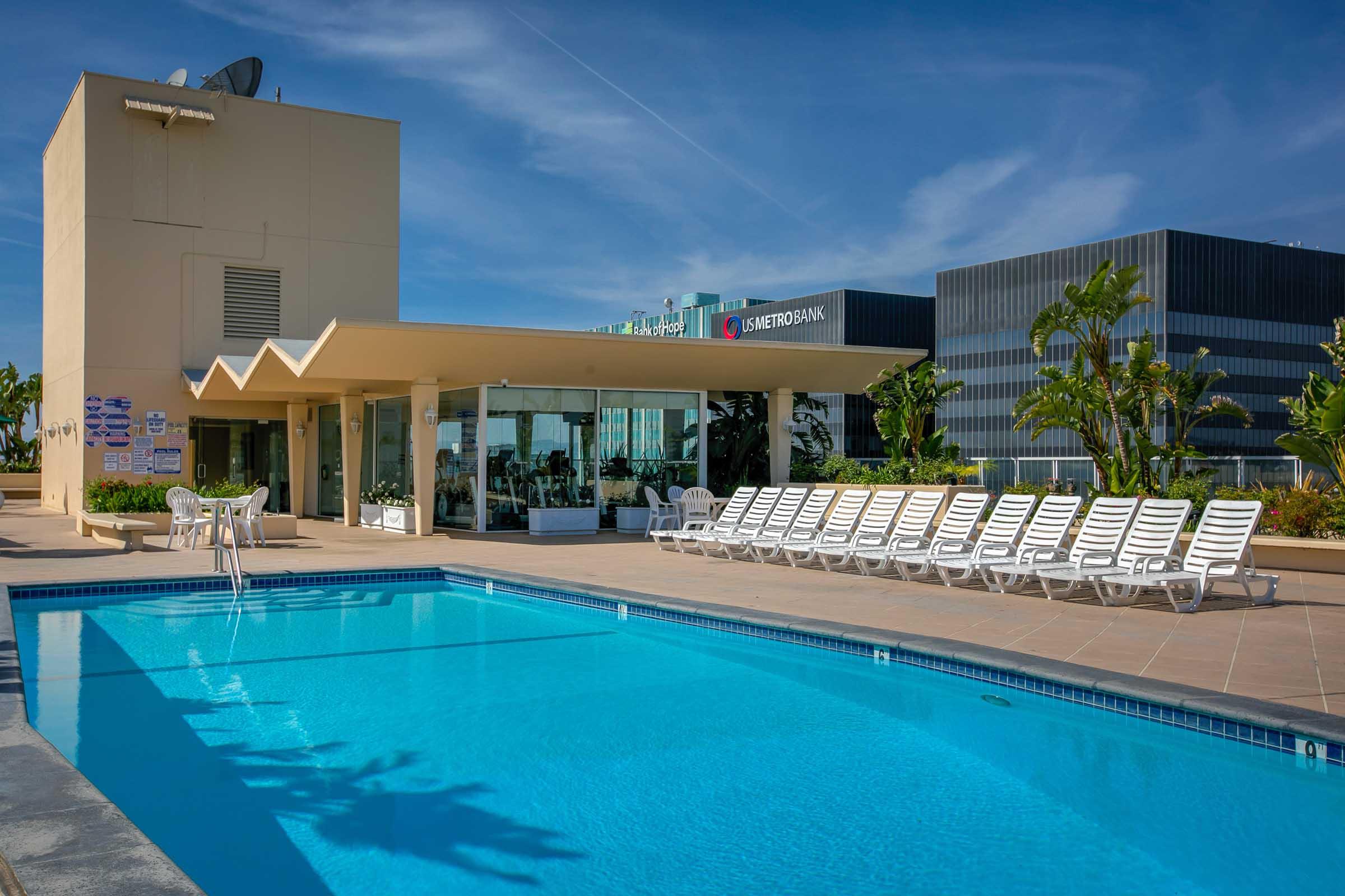 lounge chairs next to a swimming pool