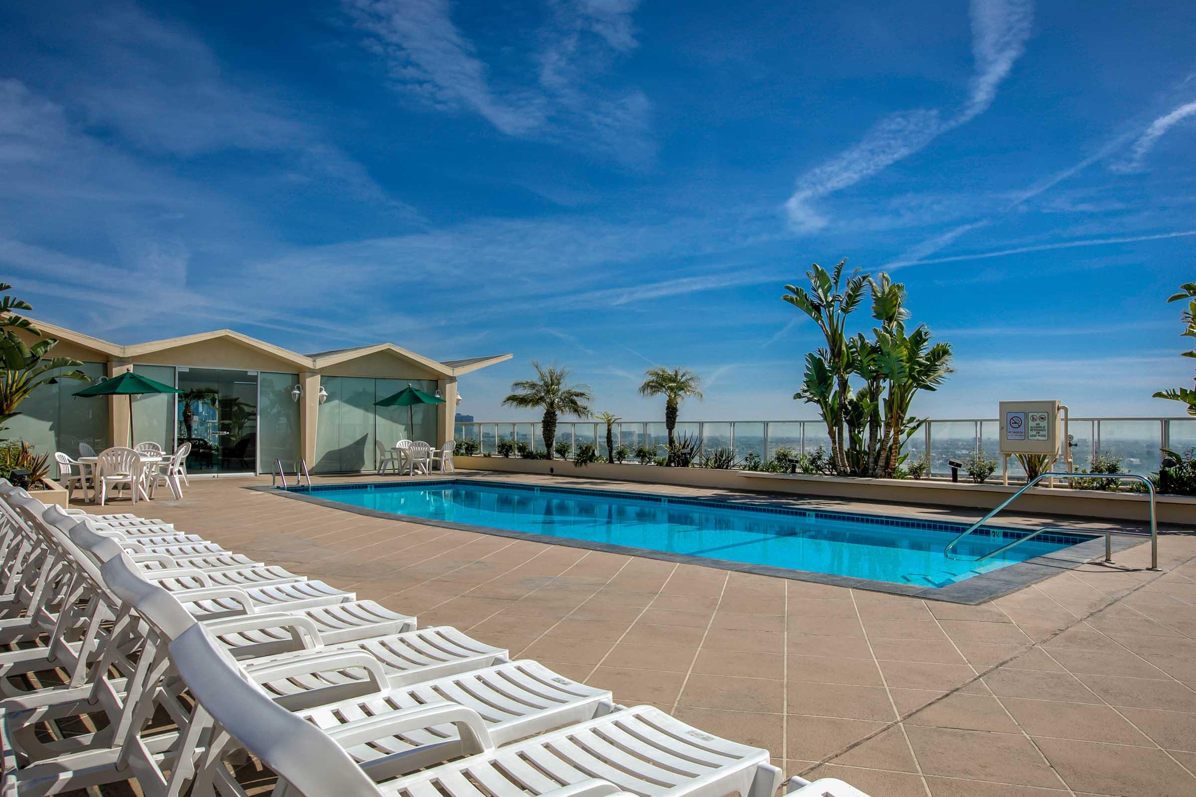 a group of lounge chairs near a swimming pool