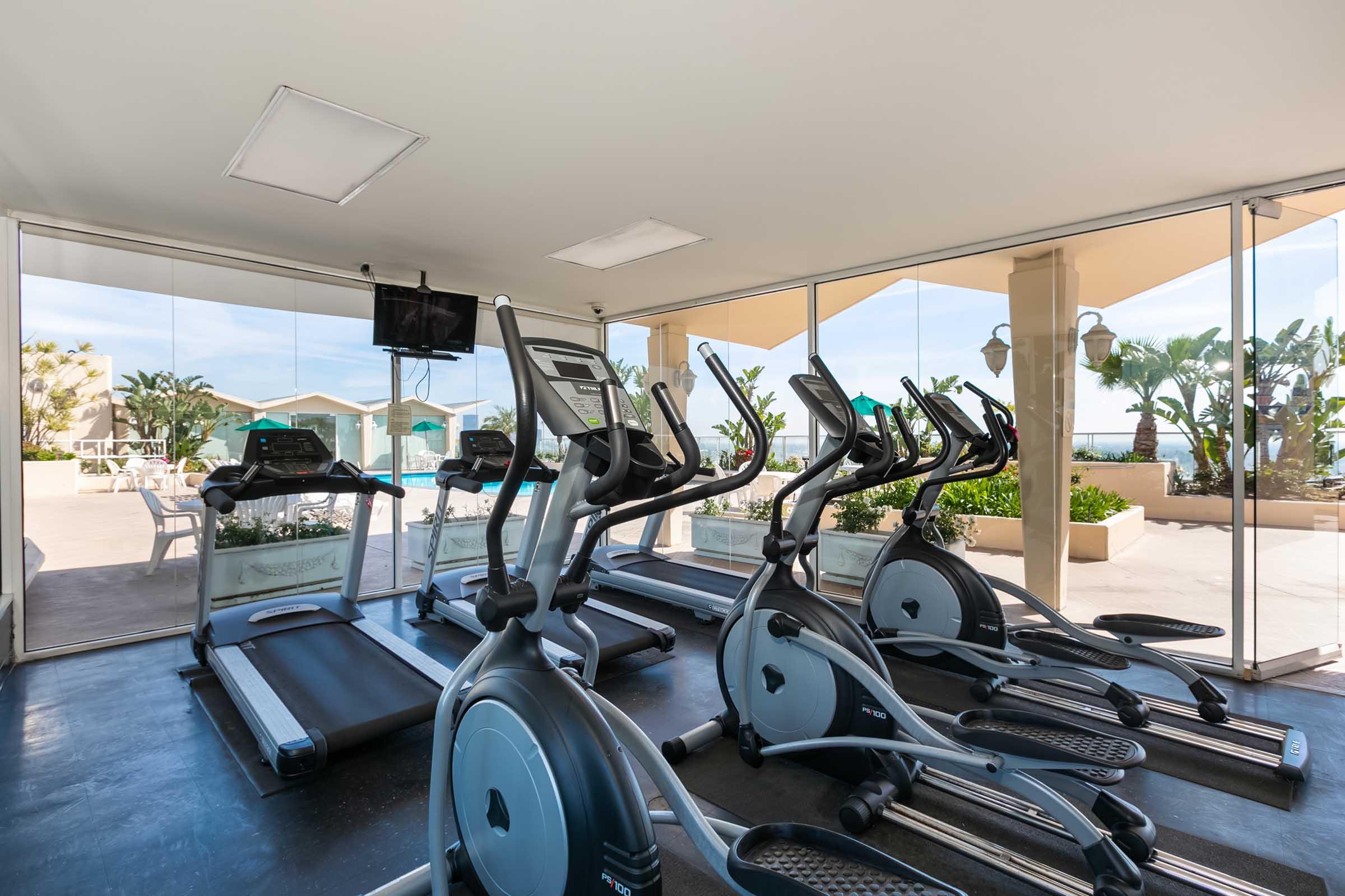 a room filled with exercise equipment and a television