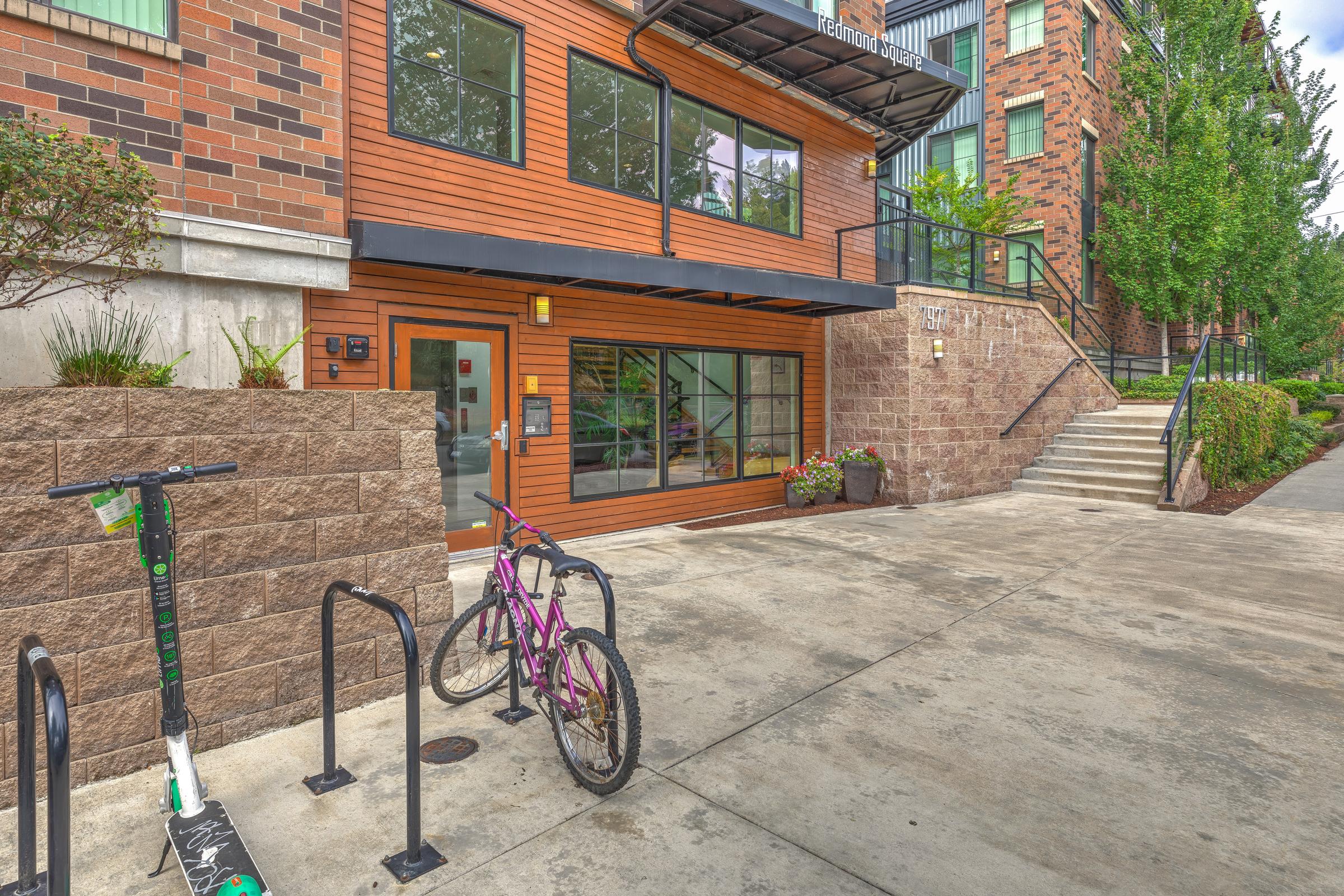 a bicycle parked in front of a brick building