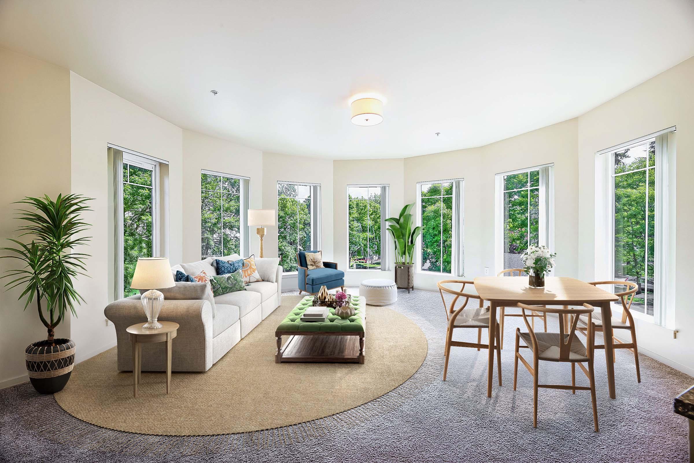 a living room filled with furniture and a large window