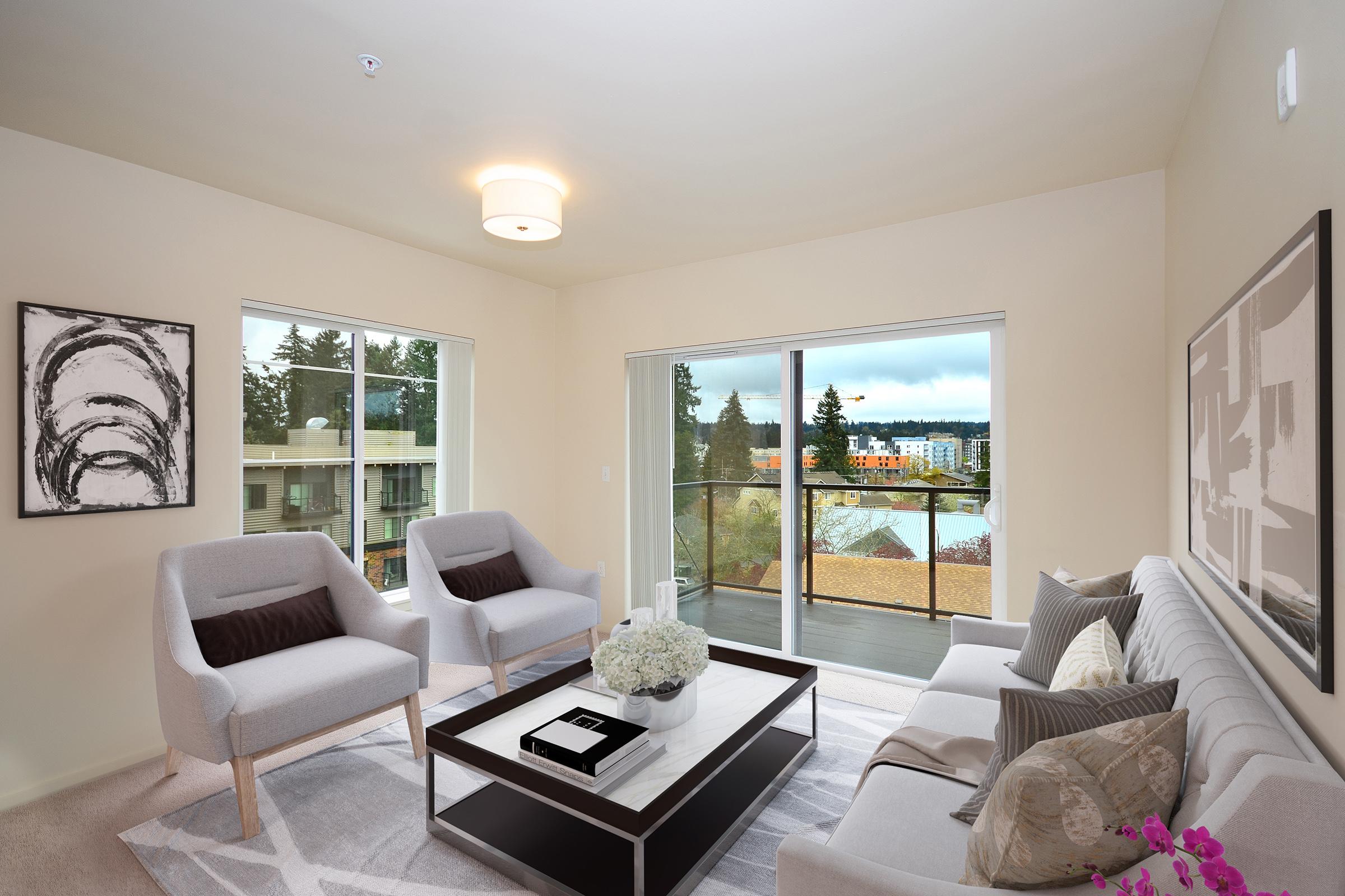 a living room filled with furniture and a large window