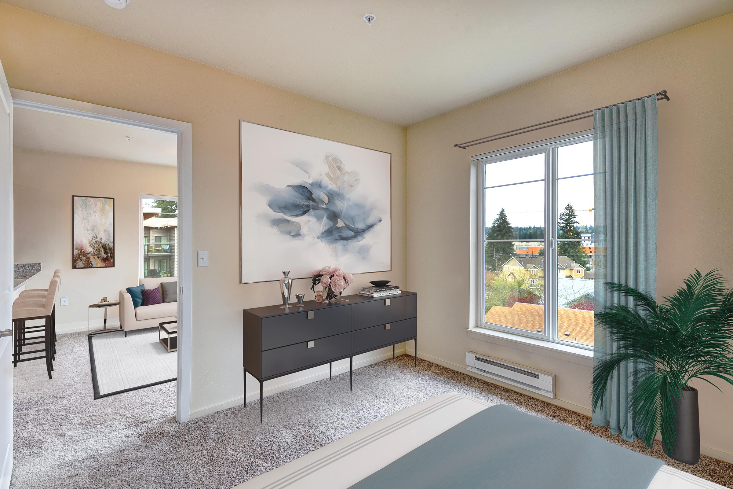 a living room filled with furniture and a large window