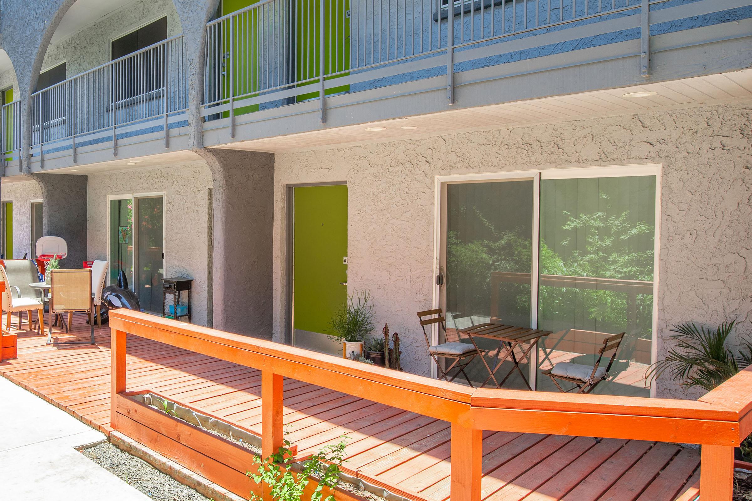 an orange bench in front of a building