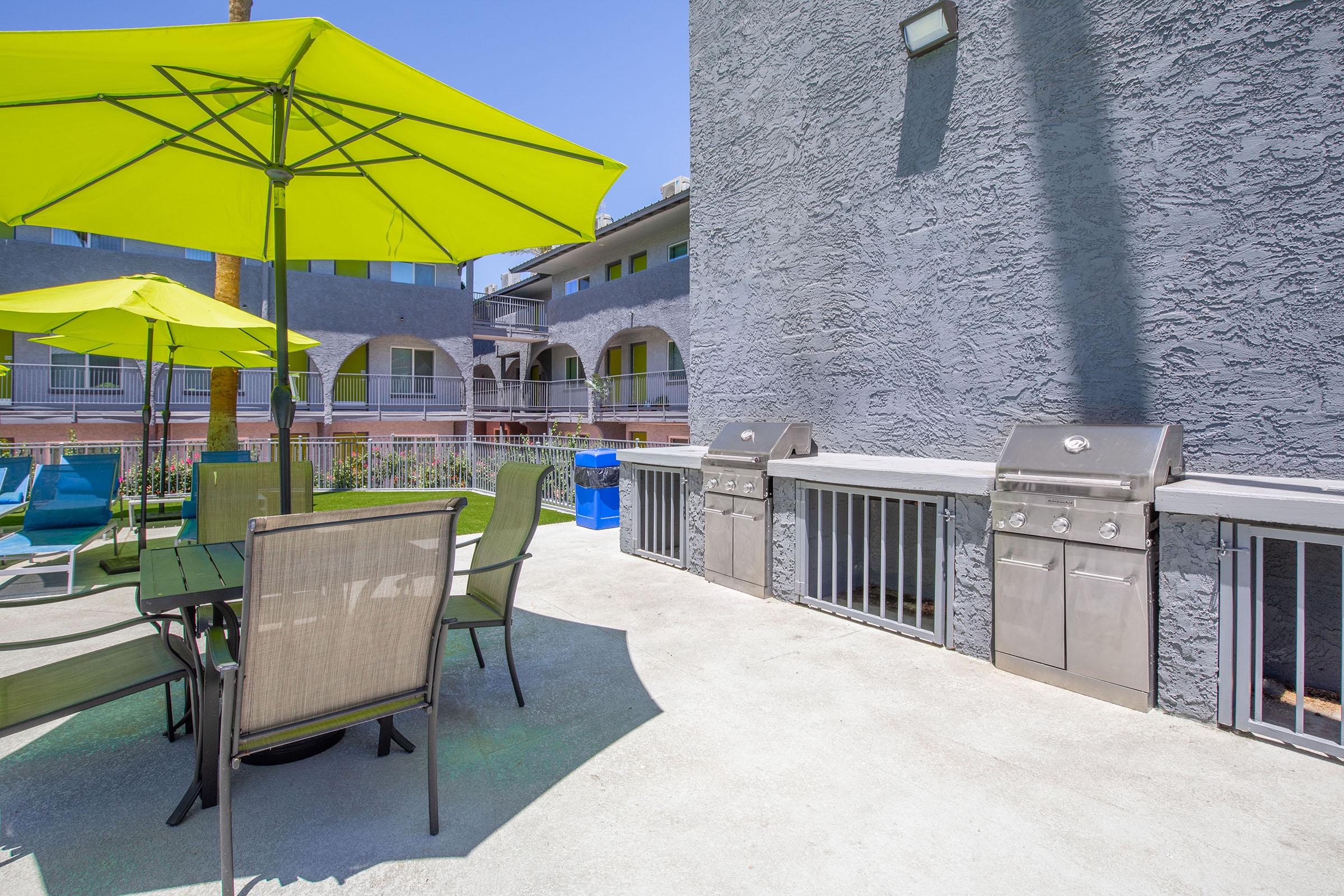 an umbrella sitting on top of a bench in front of a building