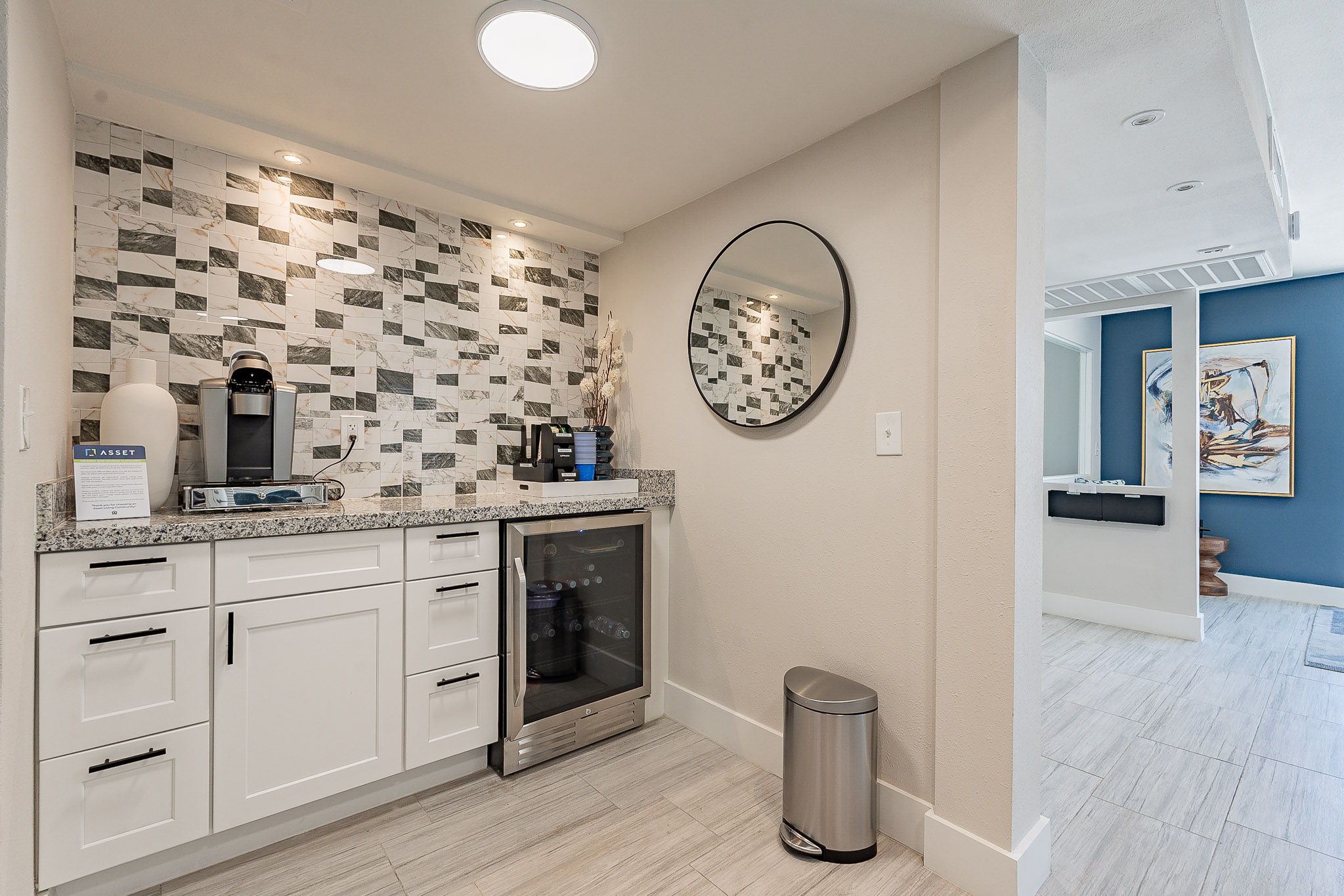 a kitchen with a sink and a mirror