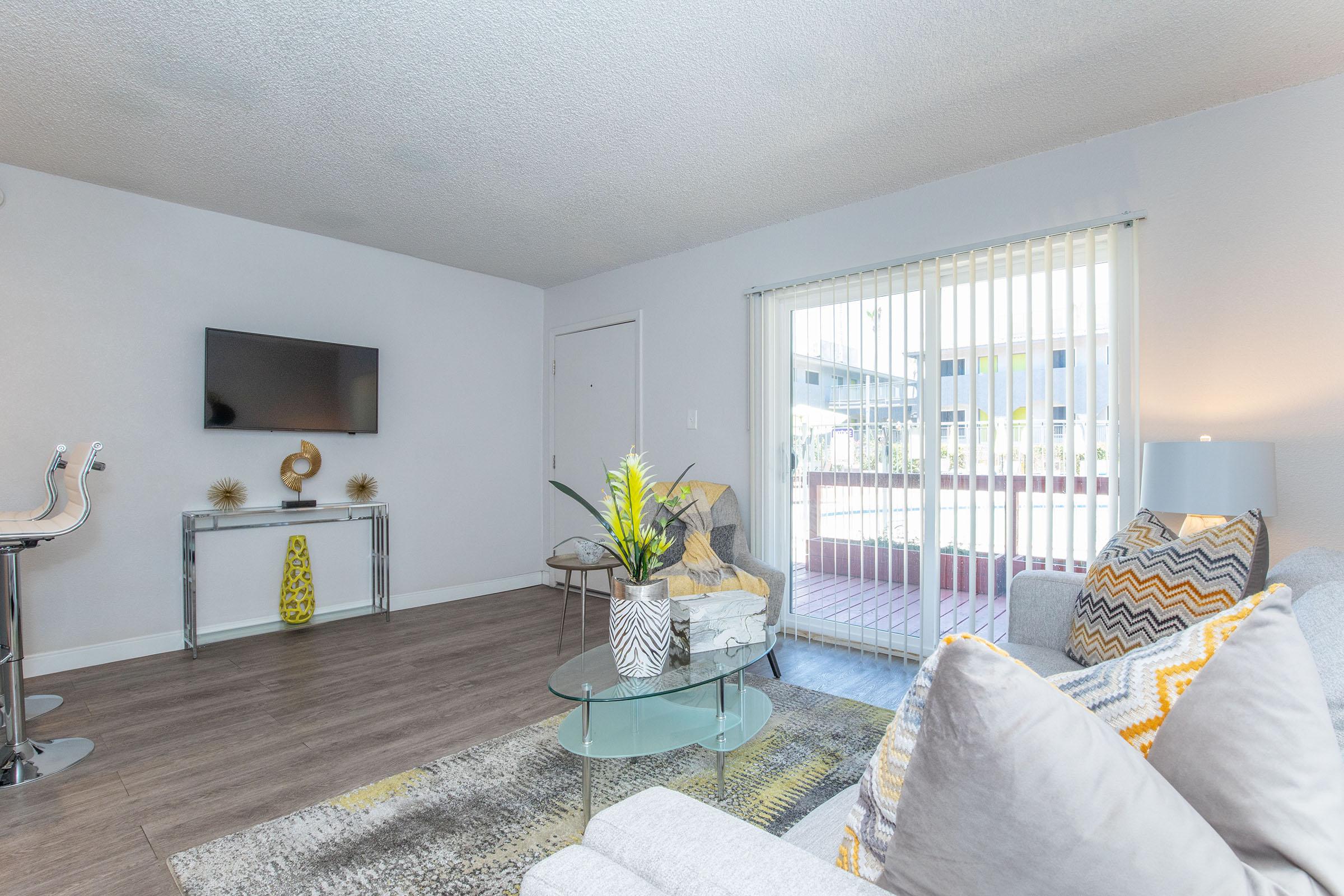 a living room filled with furniture and a flat screen tv