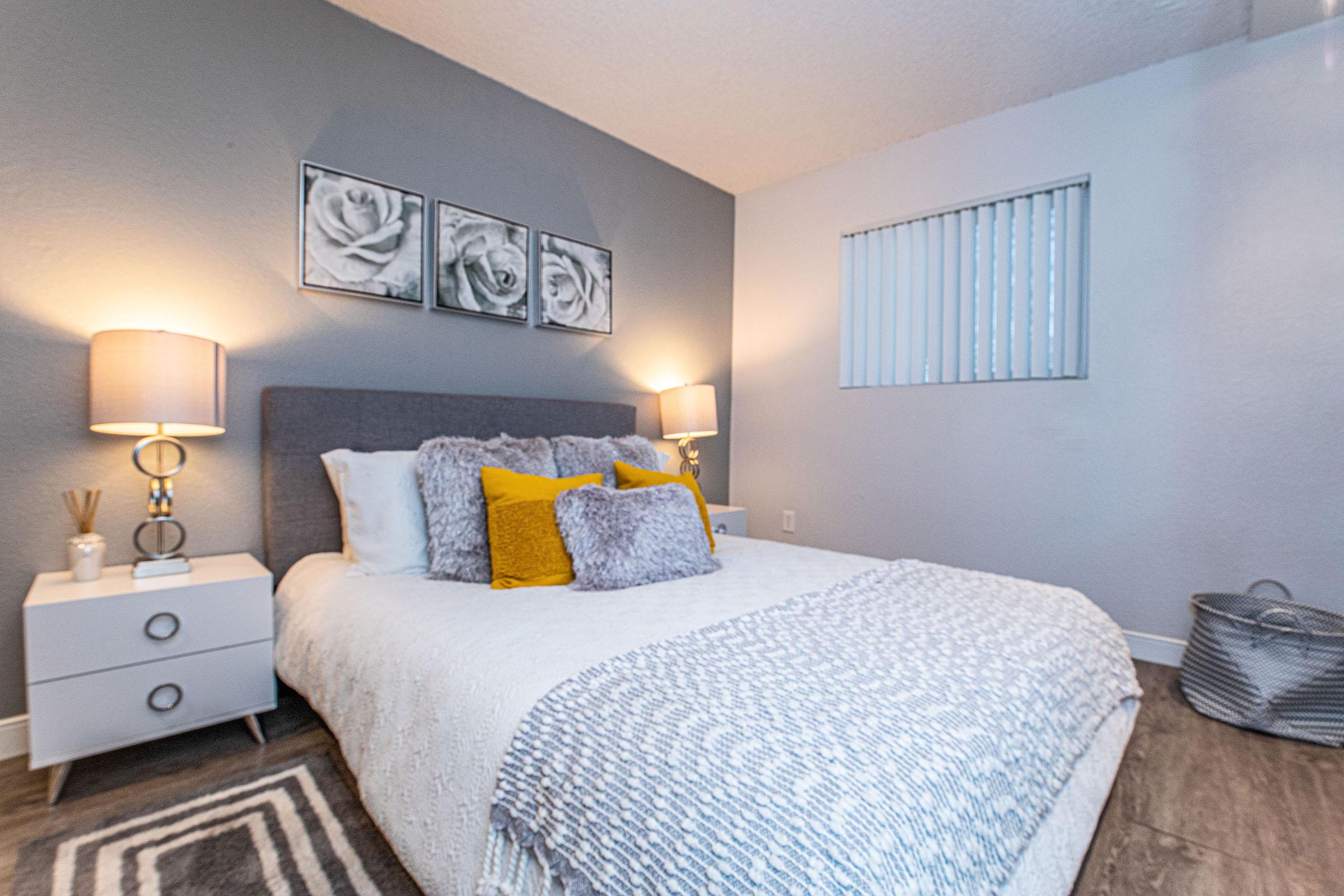 a bedroom with a bed and desk in a hotel room