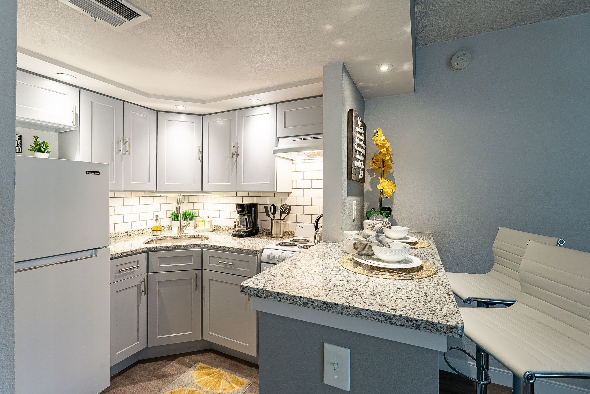 a kitchen with a sink and a refrigerator