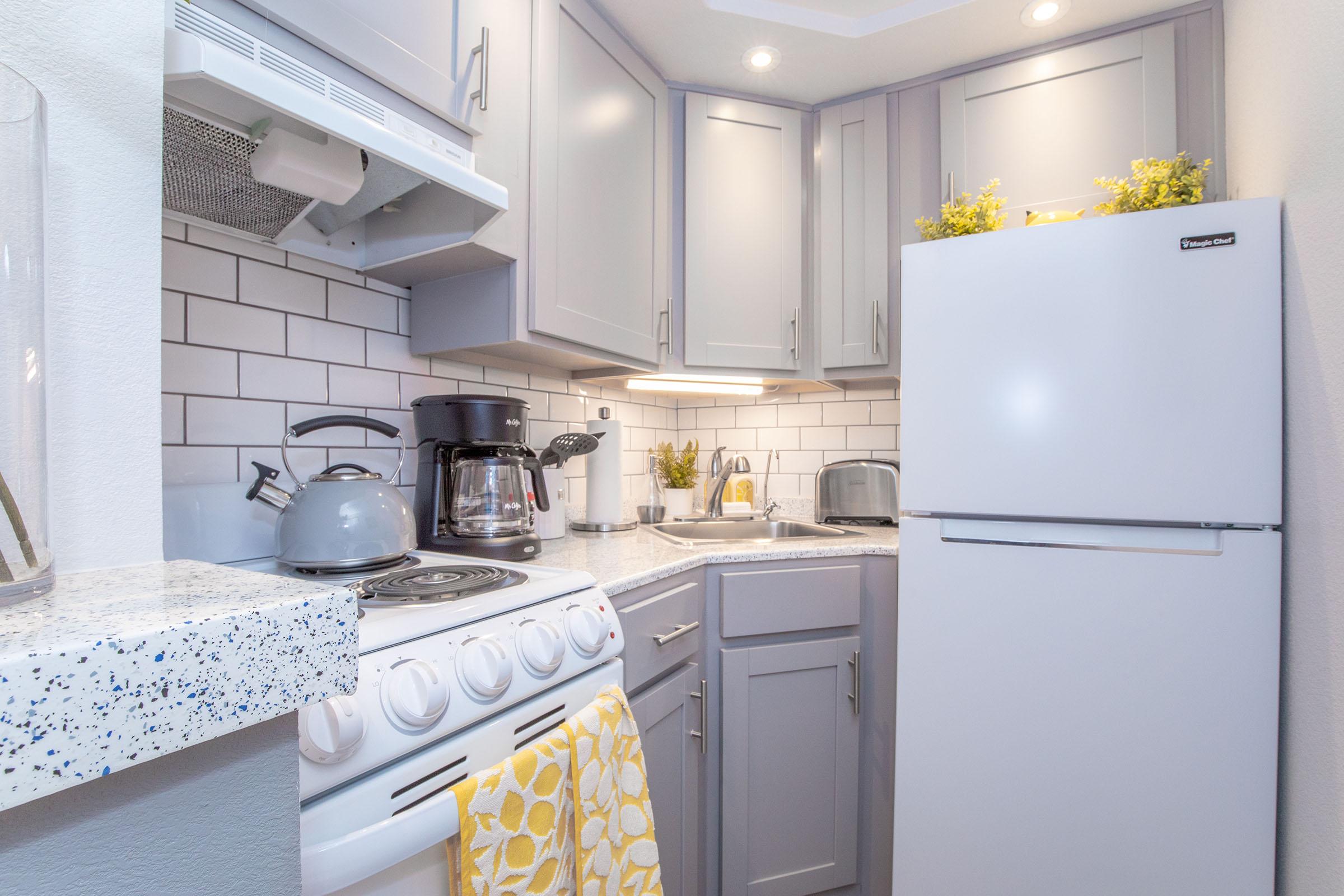 a kitchen with a stove and a refrigerator