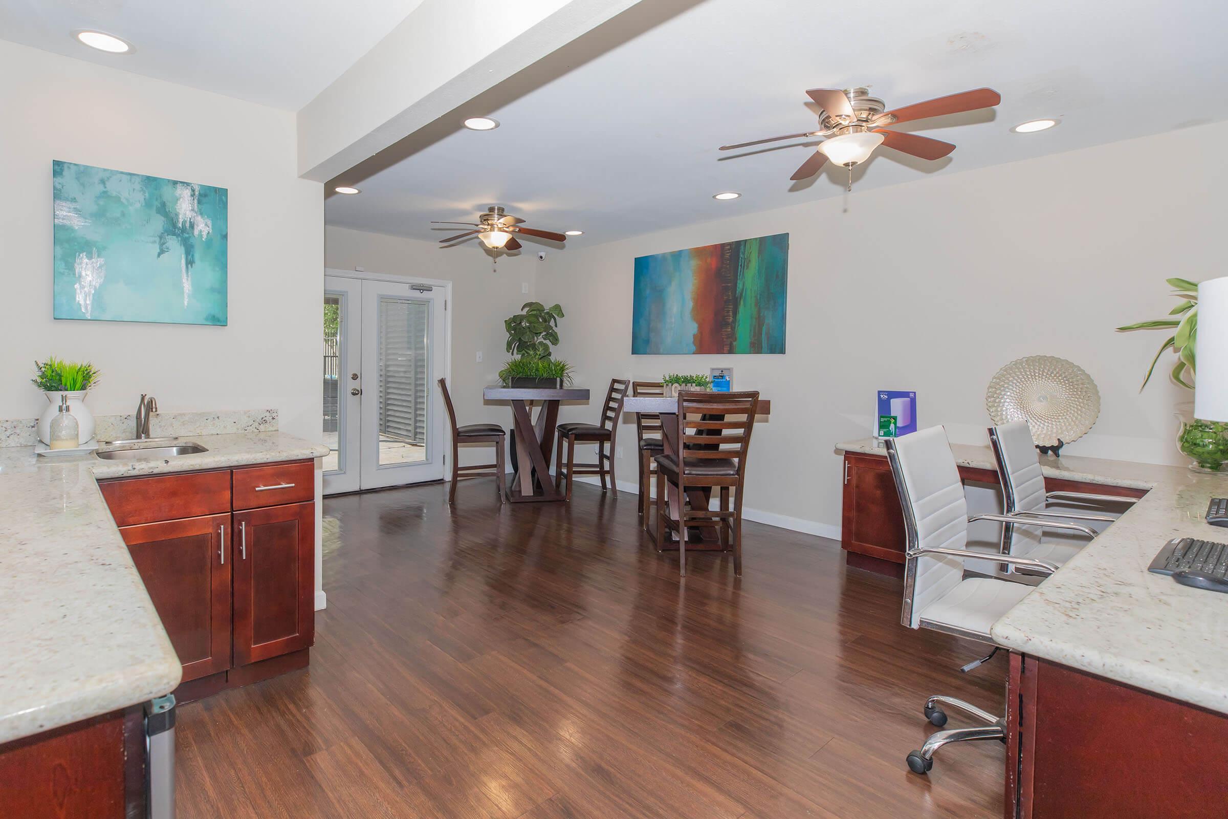 a living room filled with furniture and a wood floor