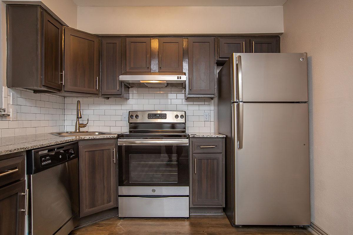 a kitchen with a stove and a refrigerator