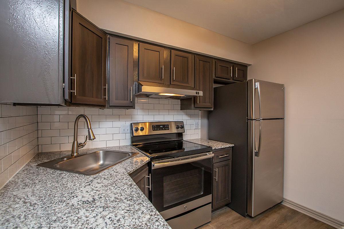 a kitchen with stainless steel appliances and wooden cabinets