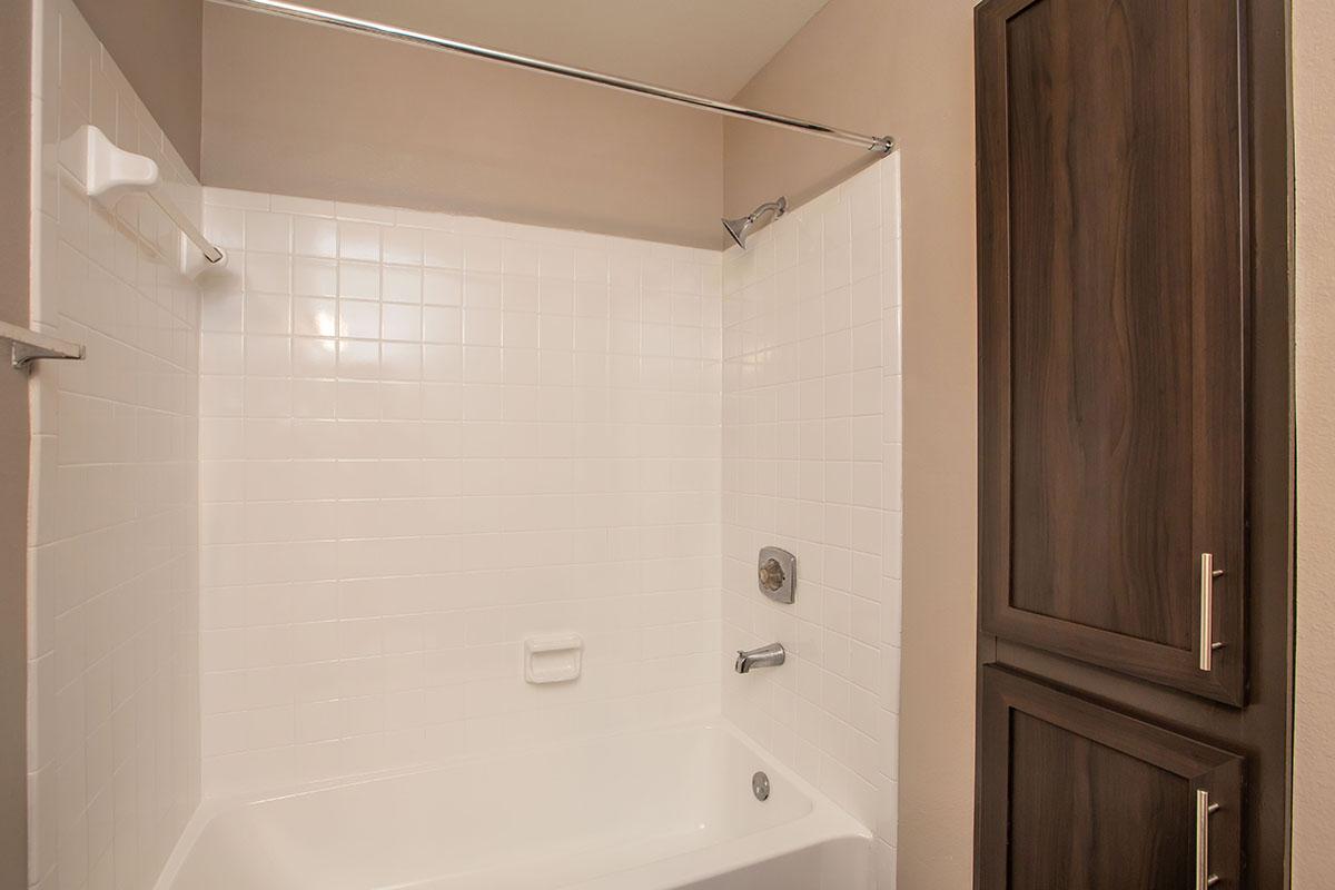 a white tub sitting next to a shower