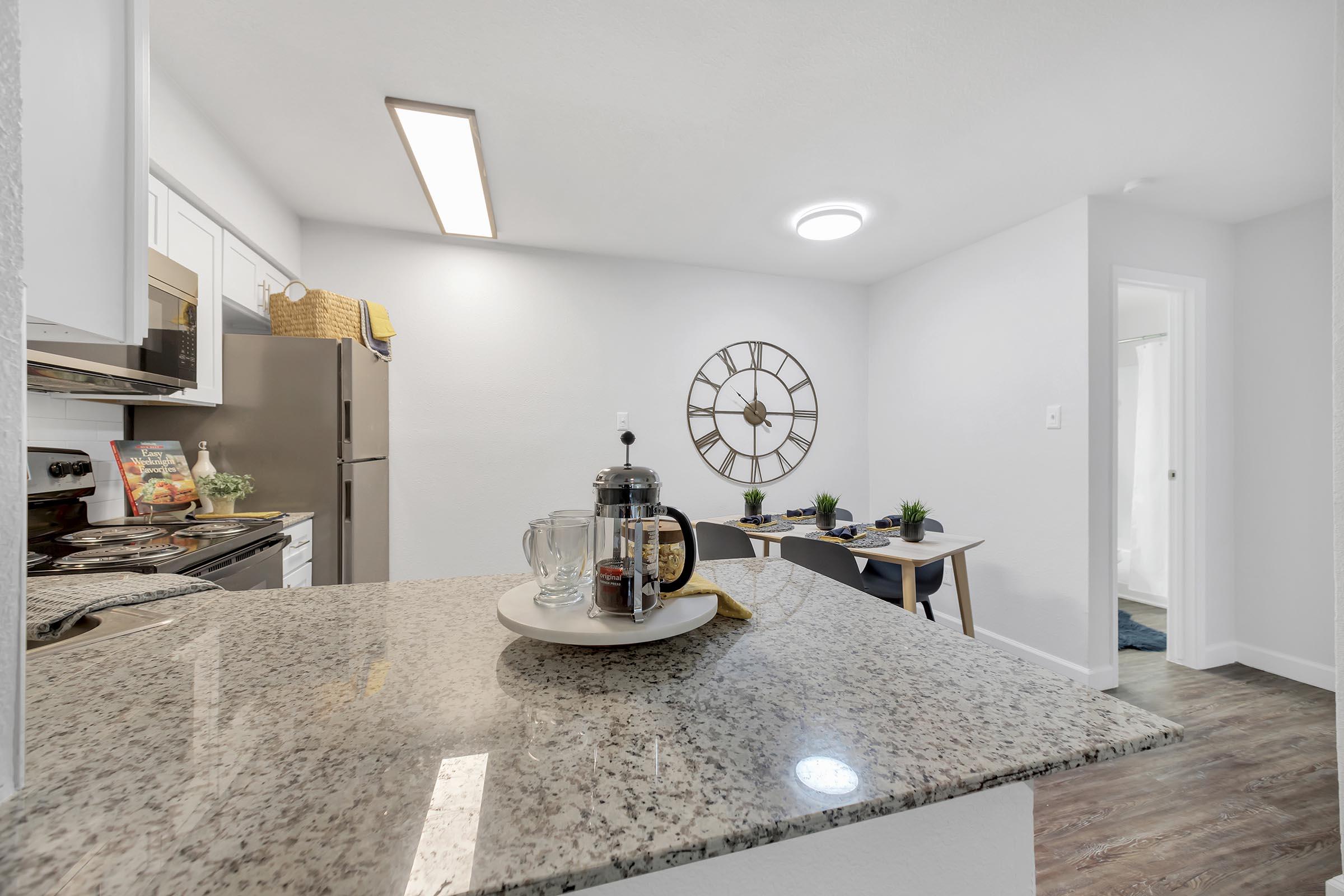 a kitchen with a clock on the counter