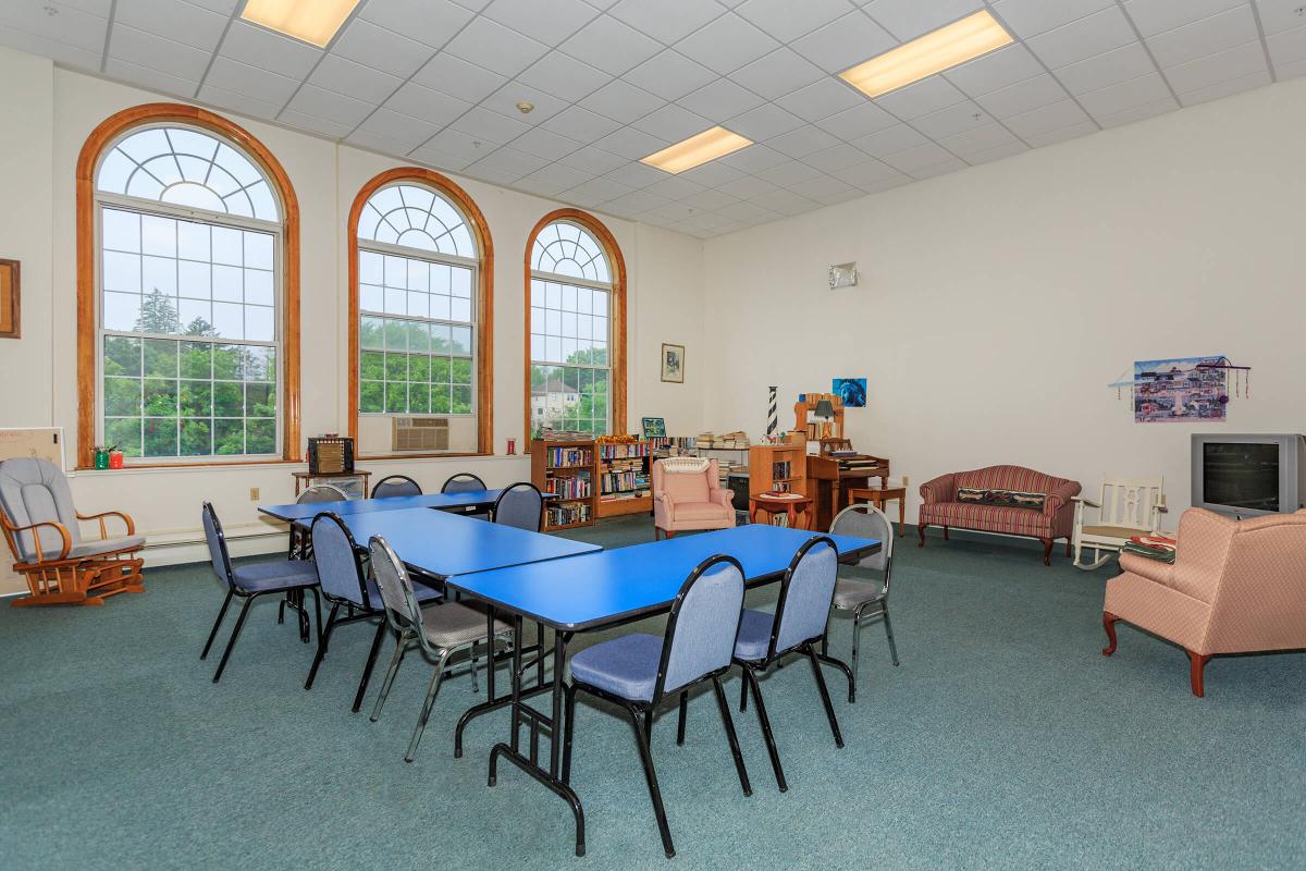 a living room filled with furniture and a large window