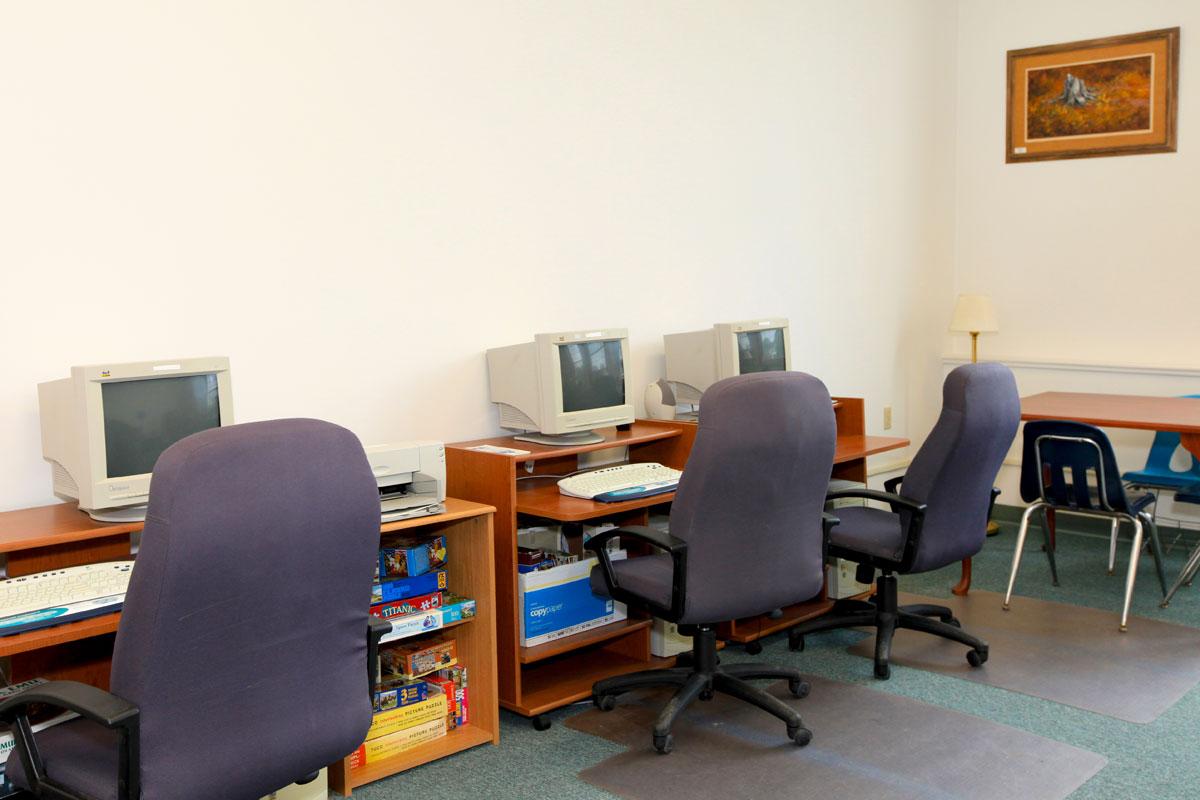 a living room with a desk and chair