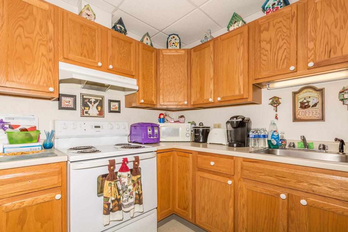 a kitchen with stainless steel appliances and wooden cabinets