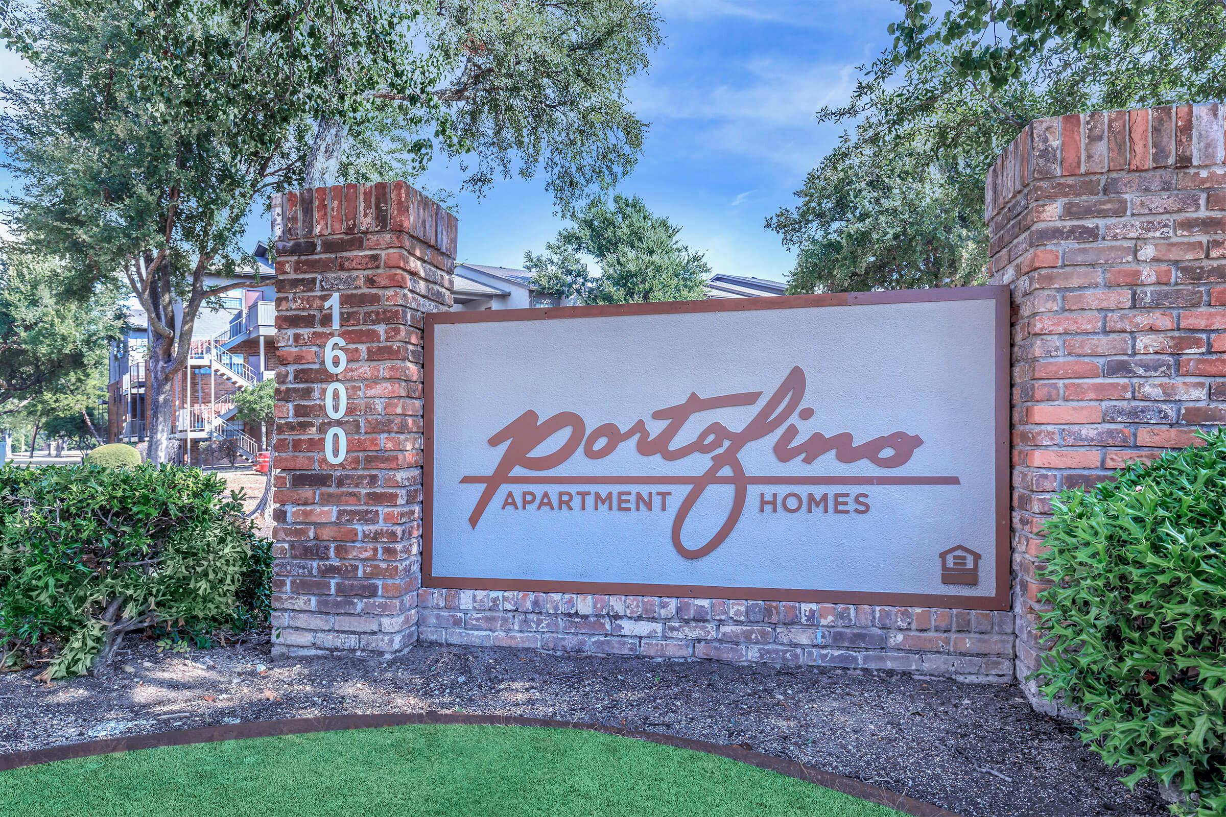 a sign in front of a brick building