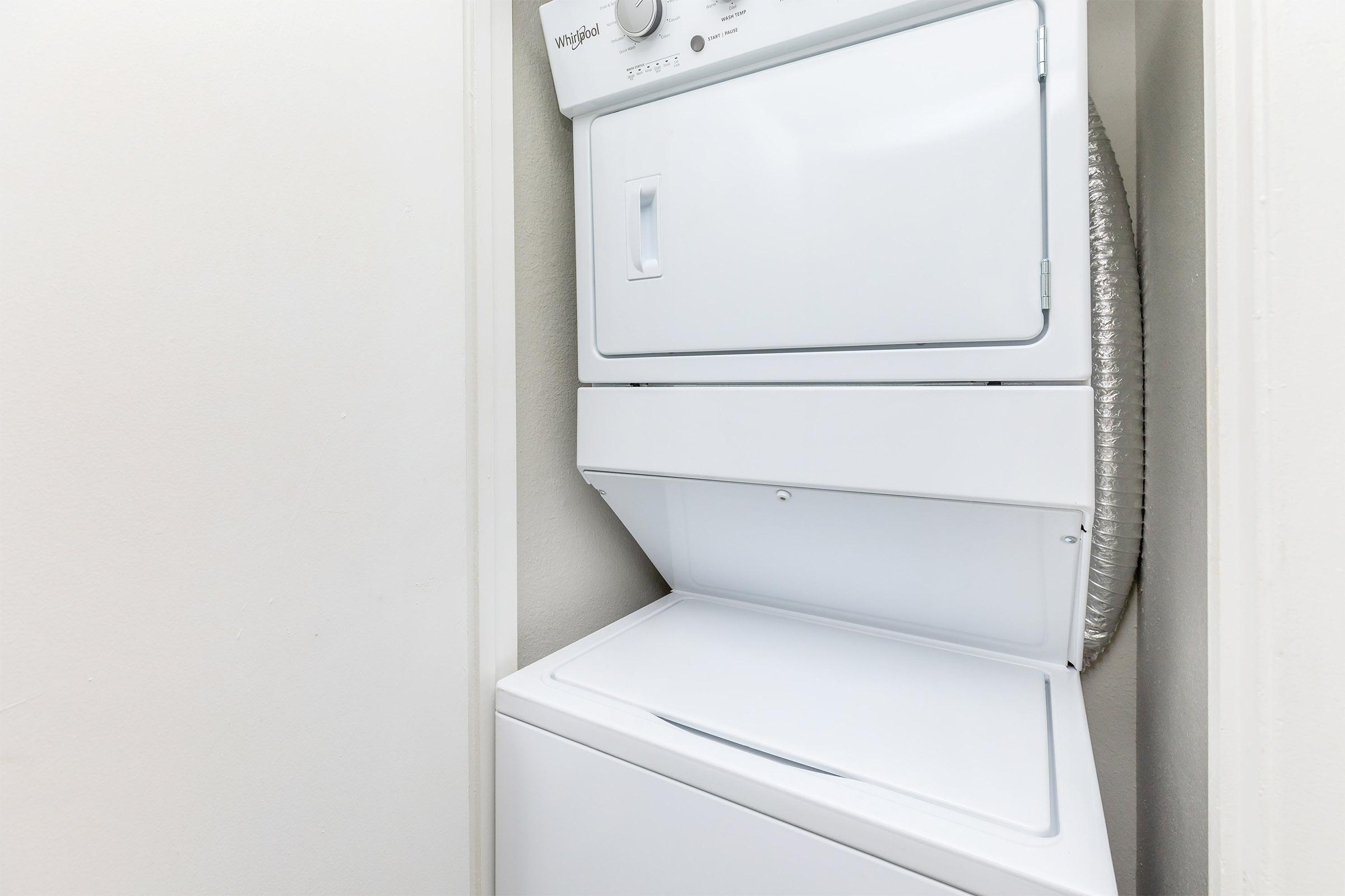 a white microwave oven sitting on top of a refrigerator