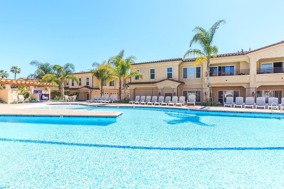 a blue pool of water in front of a building