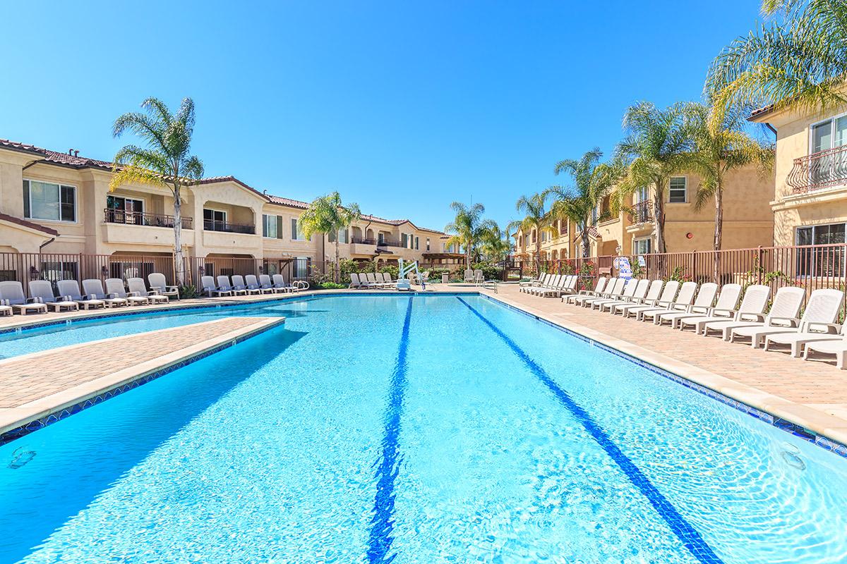 a house with a pool in front of a building