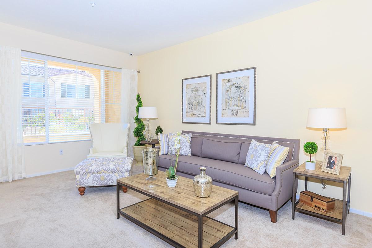 a living room filled with furniture and a flat screen tv