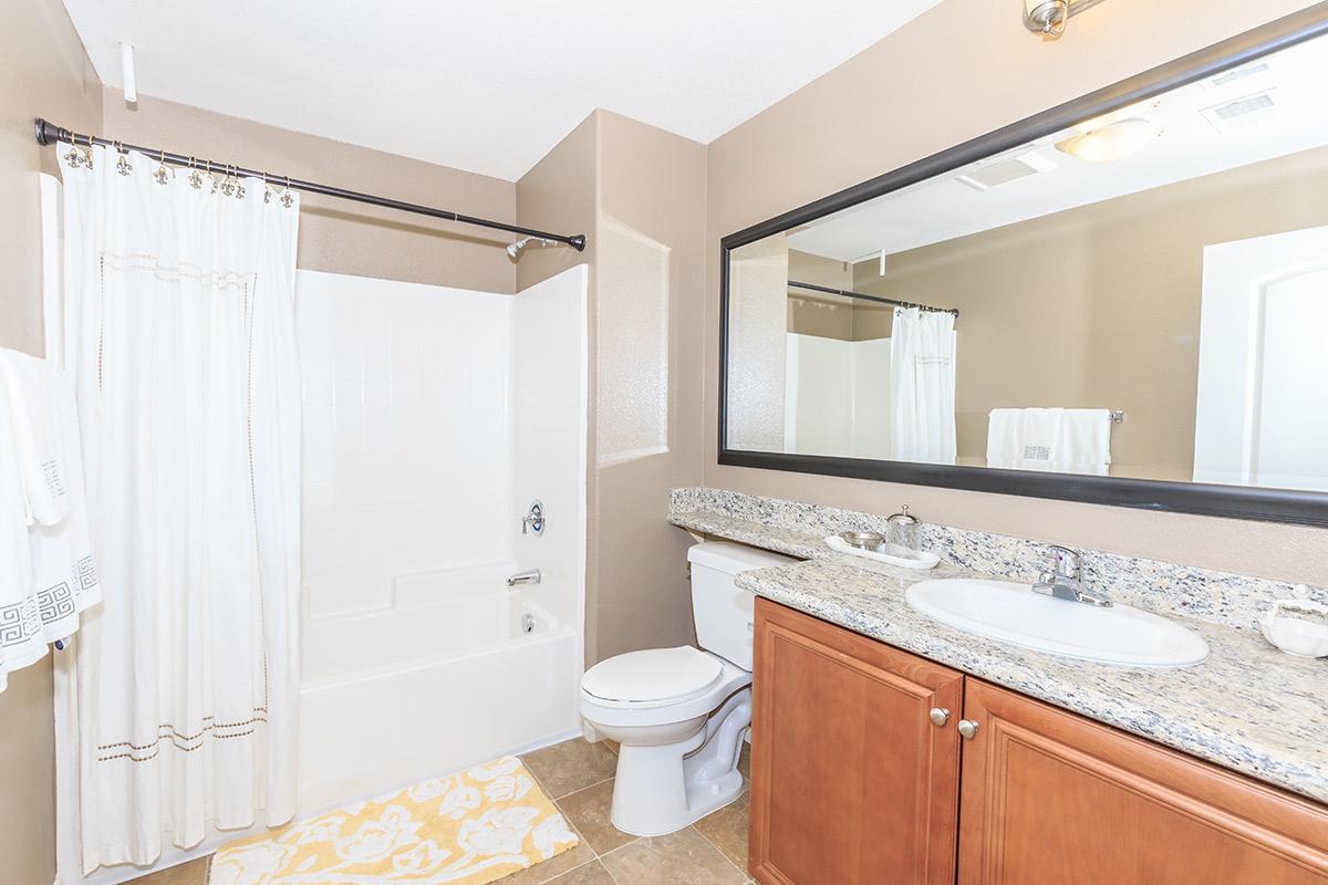 a kitchen with a sink and a mirror