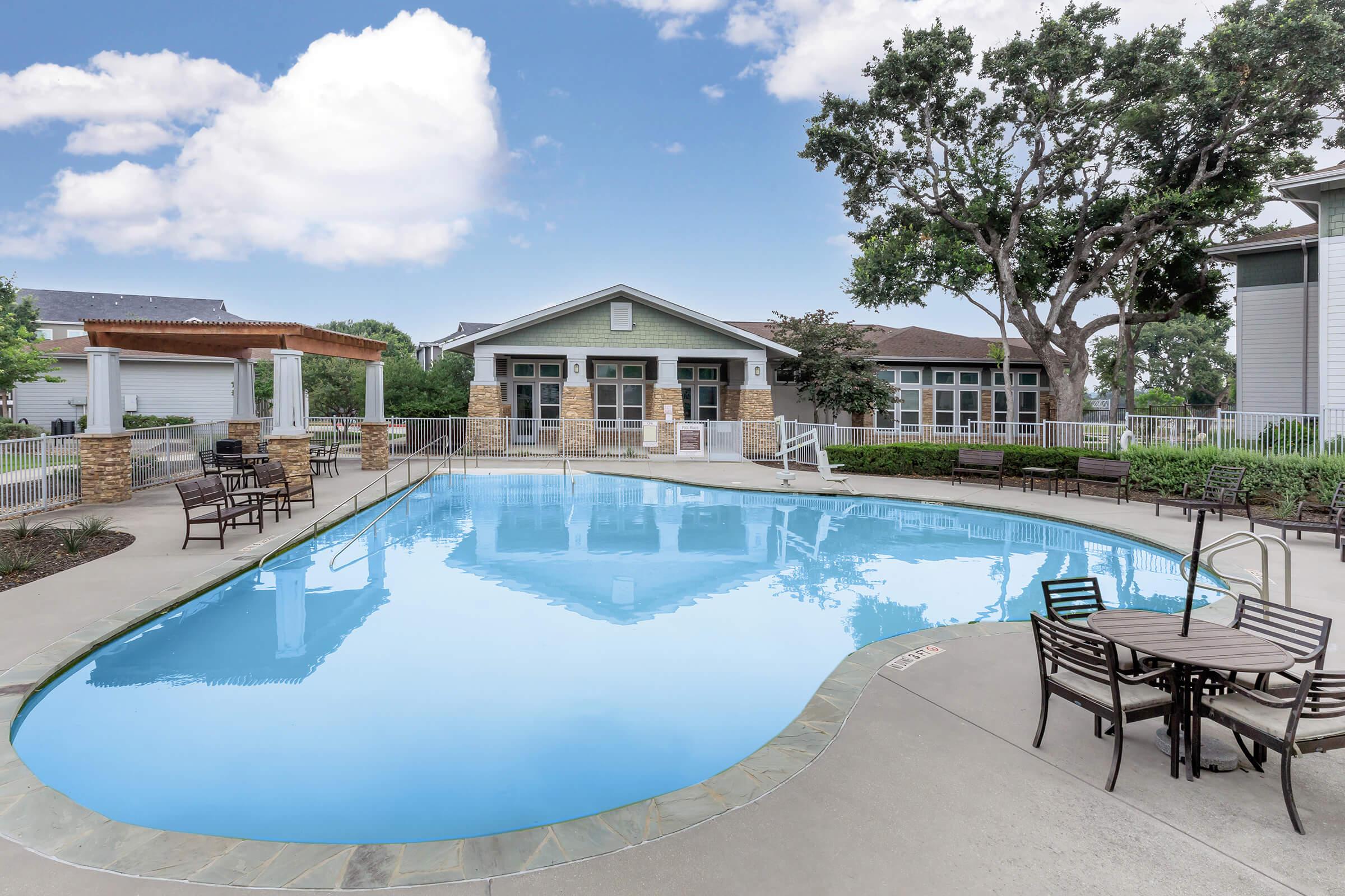 a house with a pool outside of a building