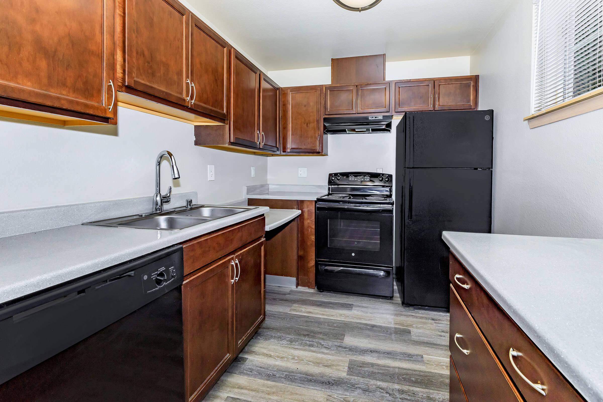 a kitchen with wooden cabinets